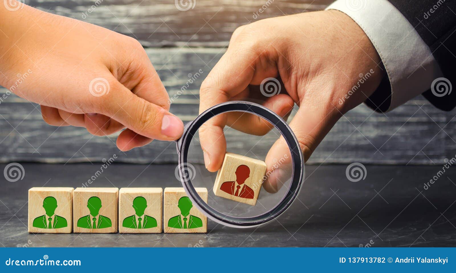 the businessman removes / dismisses the employee from the team. management within the team. wooden blocks with a picture of