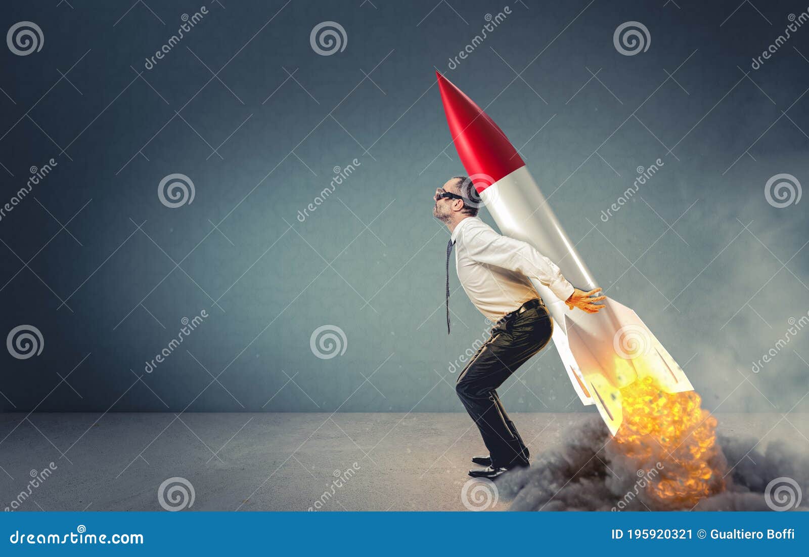 businessman with rocket on his back ready to take off