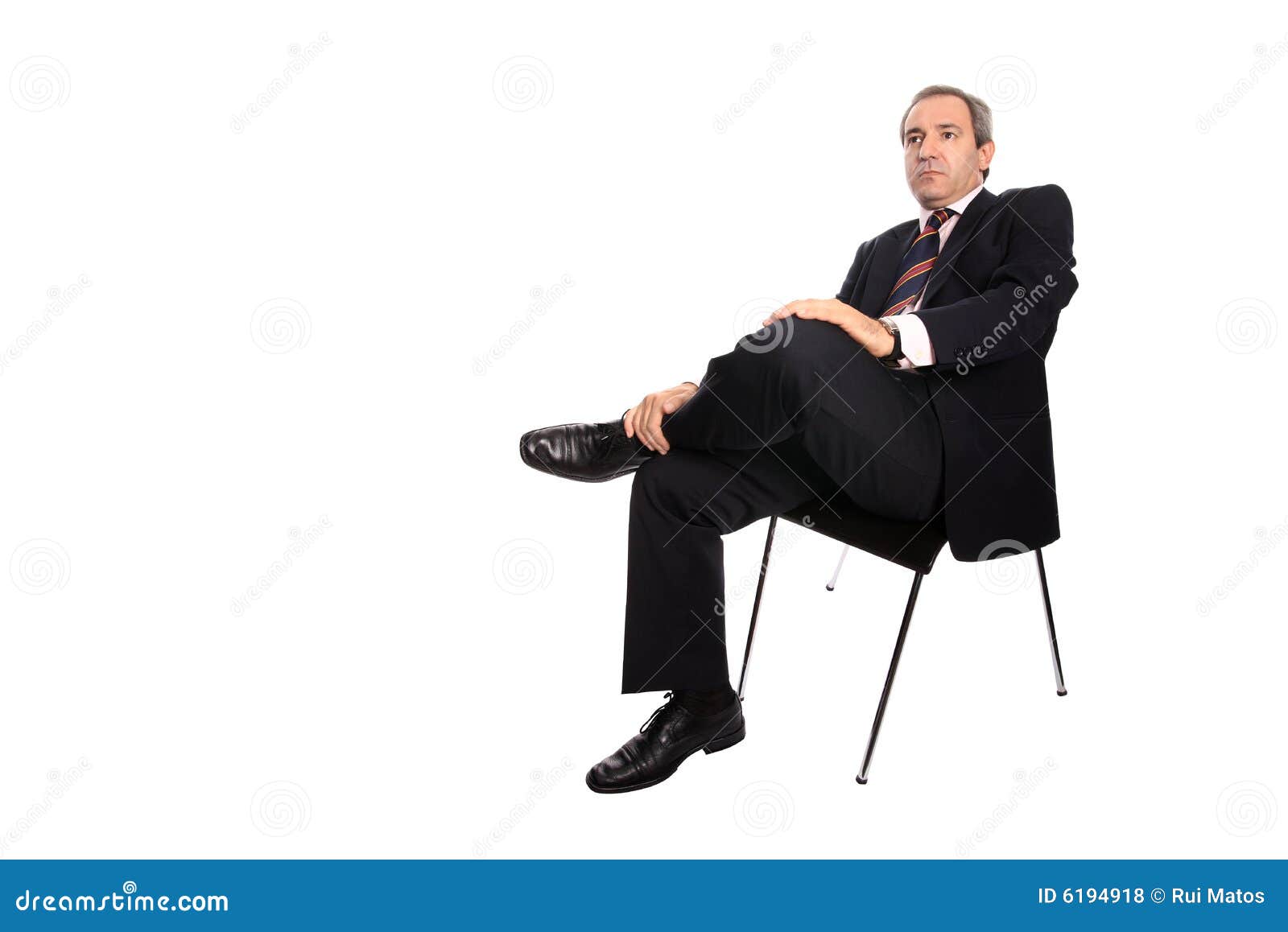 businessman seated on a chair