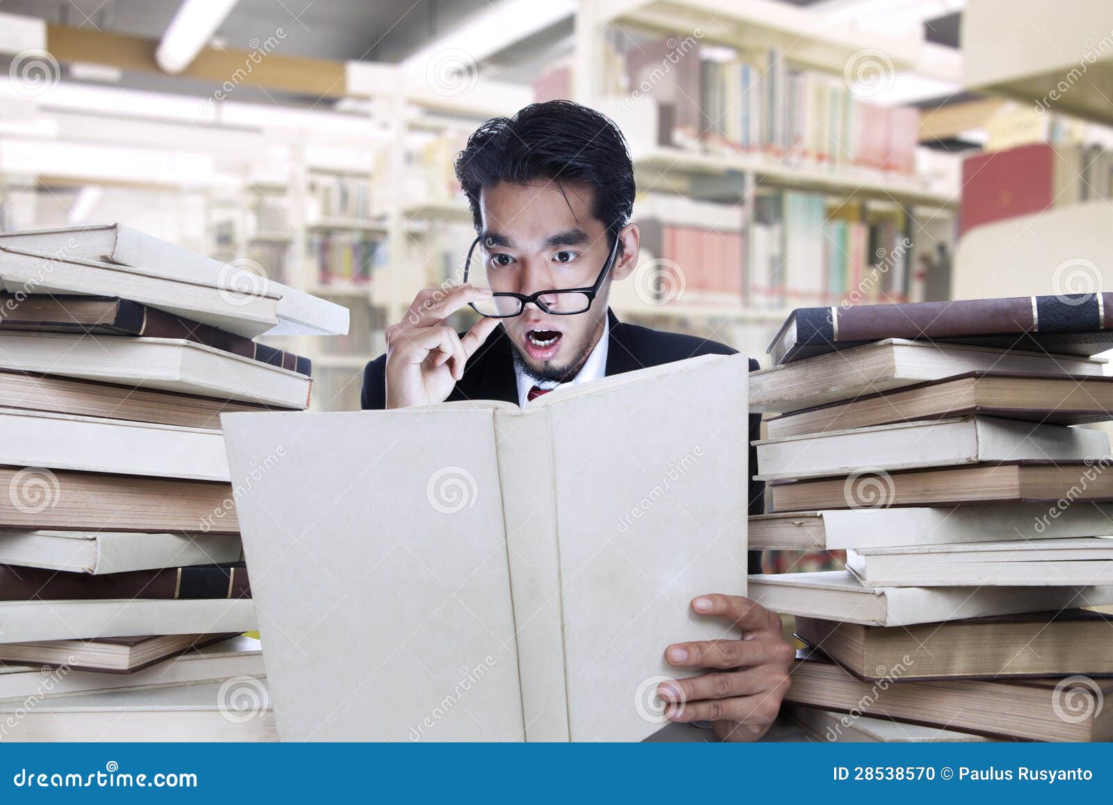 businessman shock looking at book