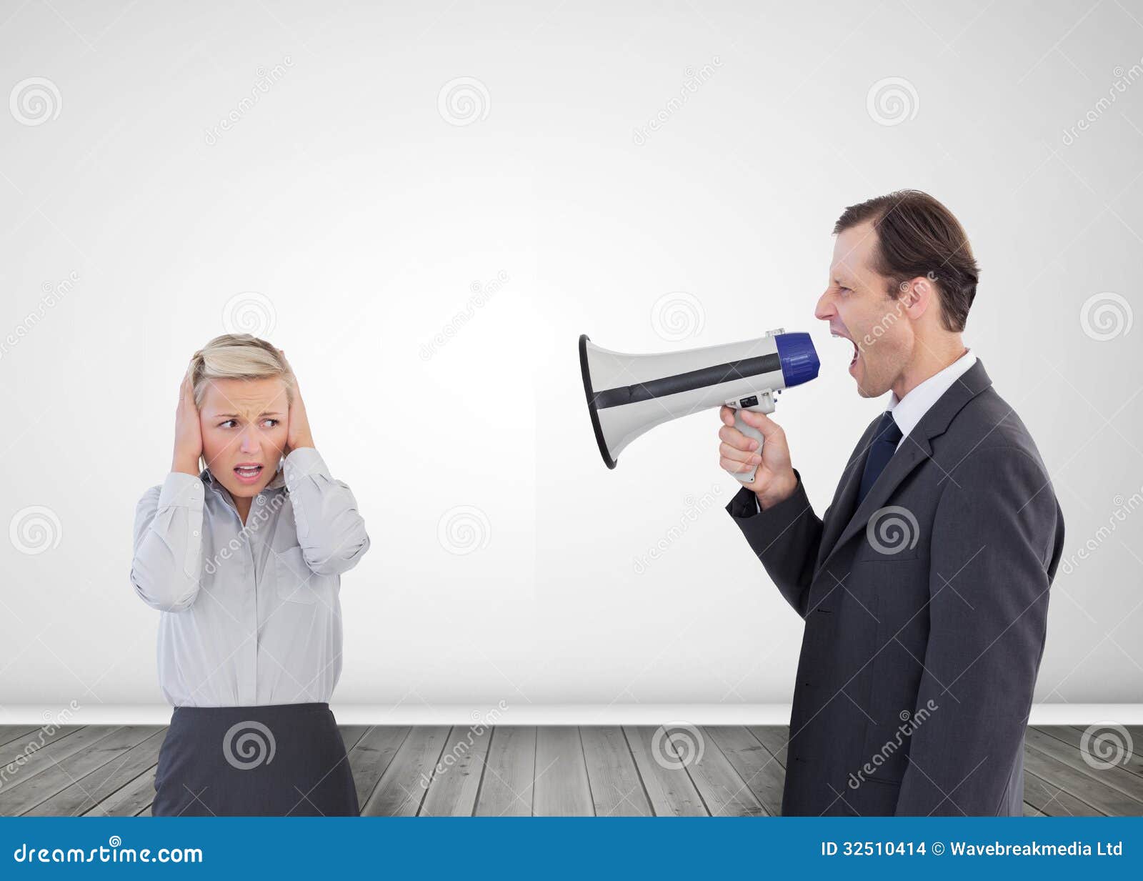 Businessman Shouting with a Megaphone at His Colleague Stock Photo