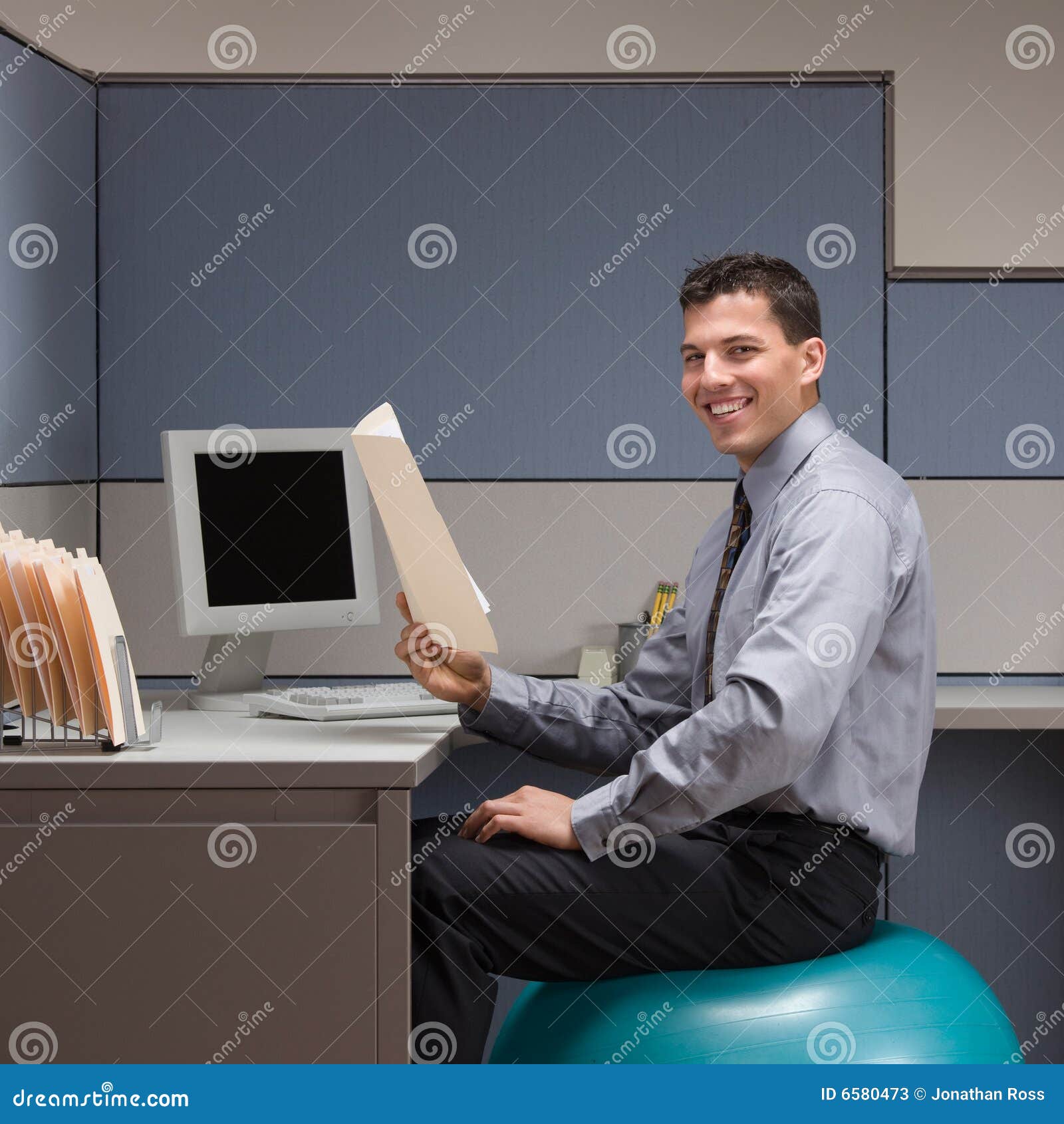 Businessman Sitting On Exercise Ball At Desk Stock Image Image