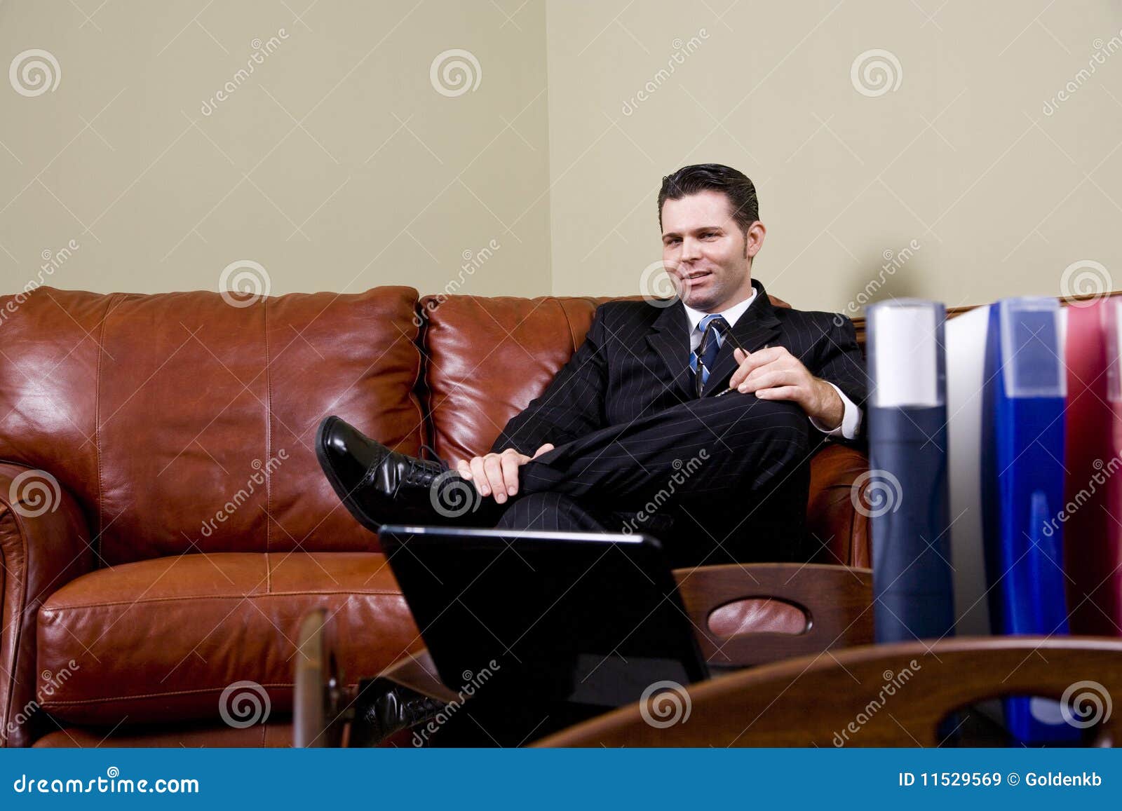 Businessman Sitting on Leather Couch in Office Stock Image Image of binders, confident 11529569