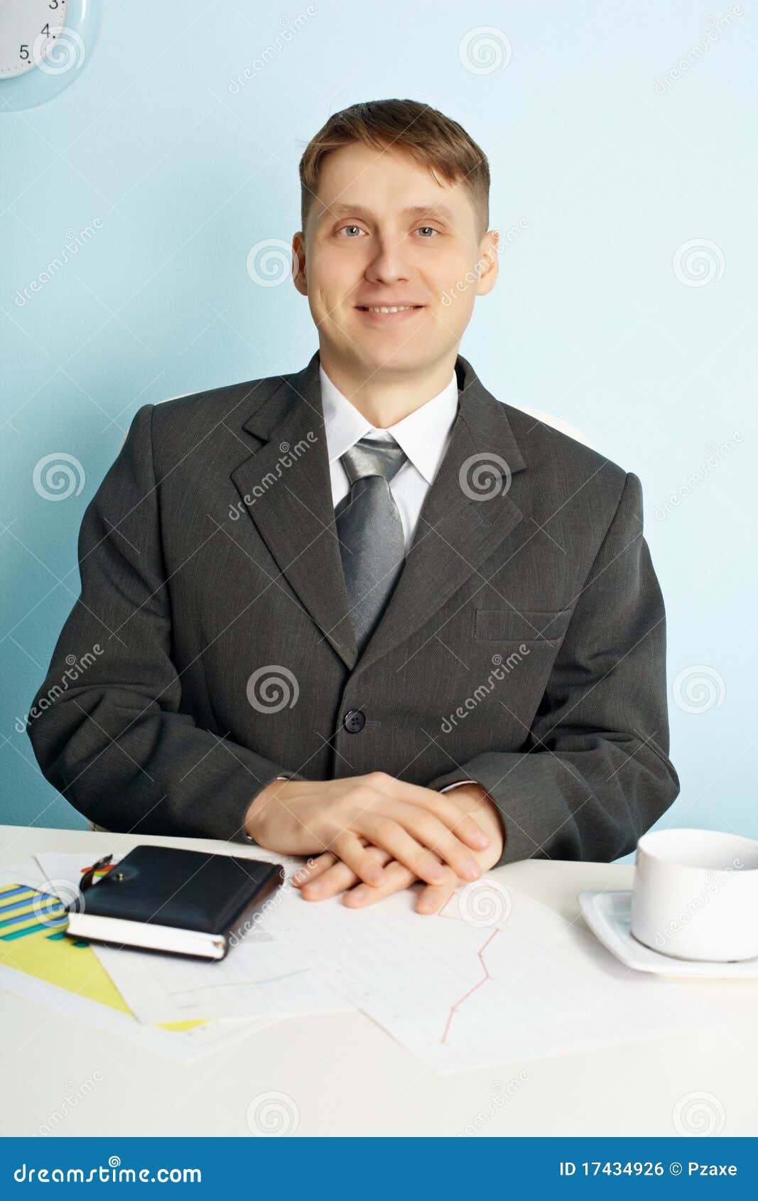 Businessman Sitting In An Office At Table Businessman Sitting In An Office At Table Stock Photo