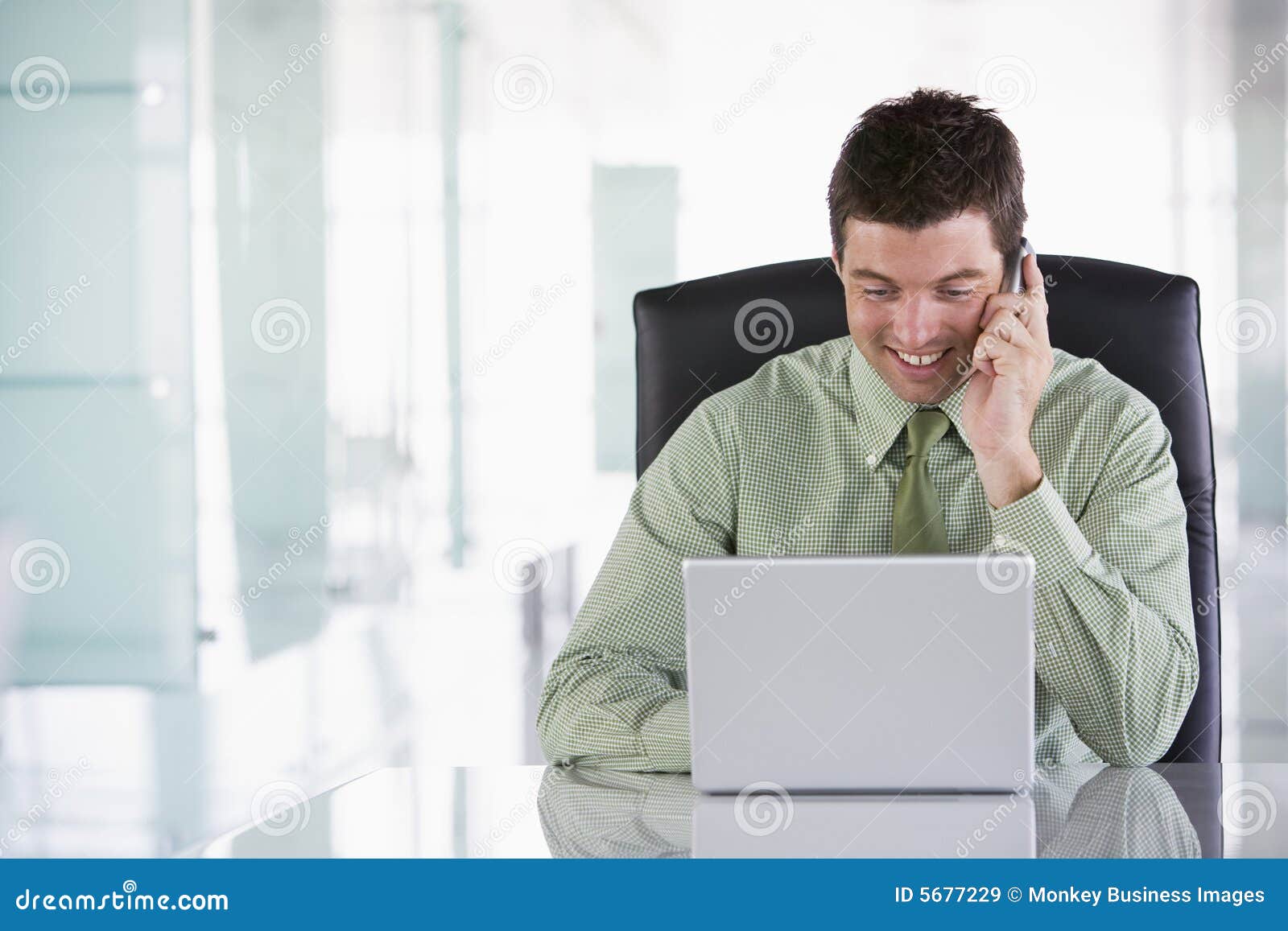 businessman sitting in office using cellular phone