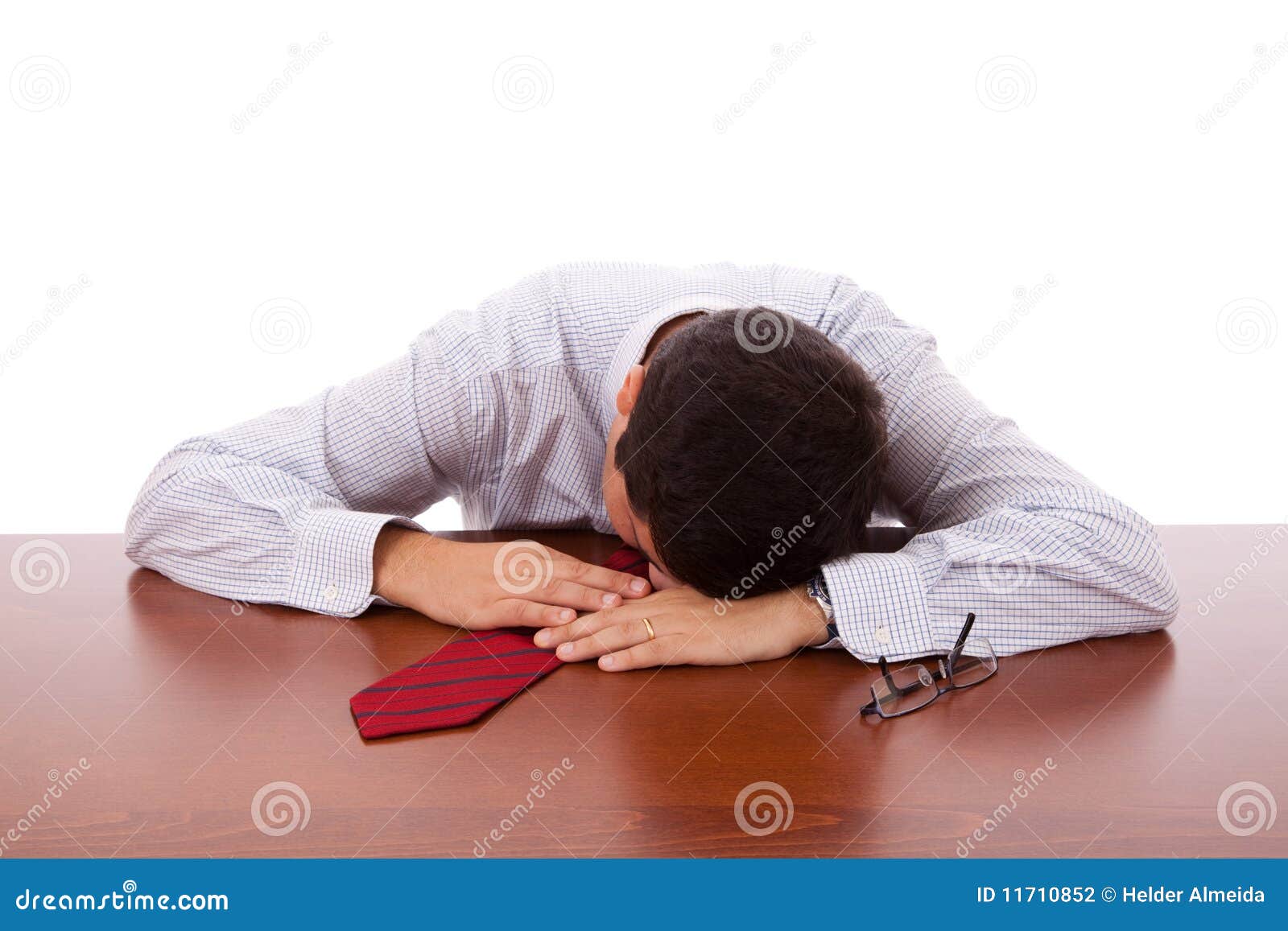 Businessman sleeping at the office (isolated on white)