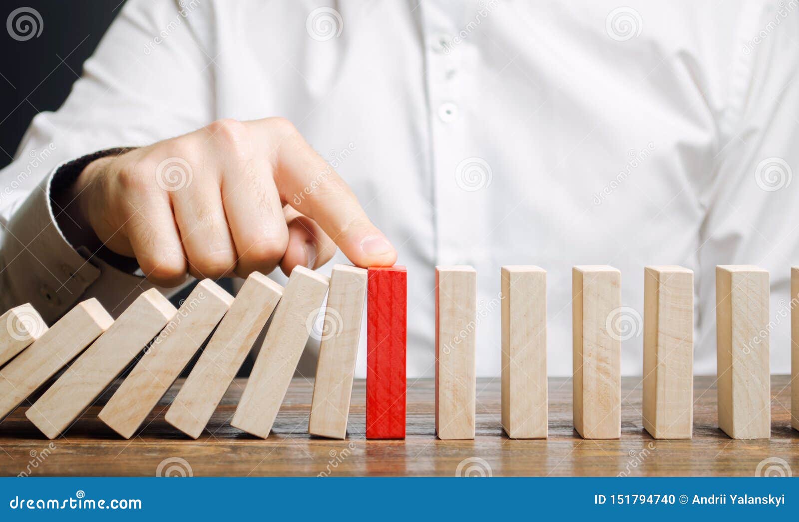 businessman stops domino falling. risk management concept. successful strong business and problem solving. reliable leader. stop