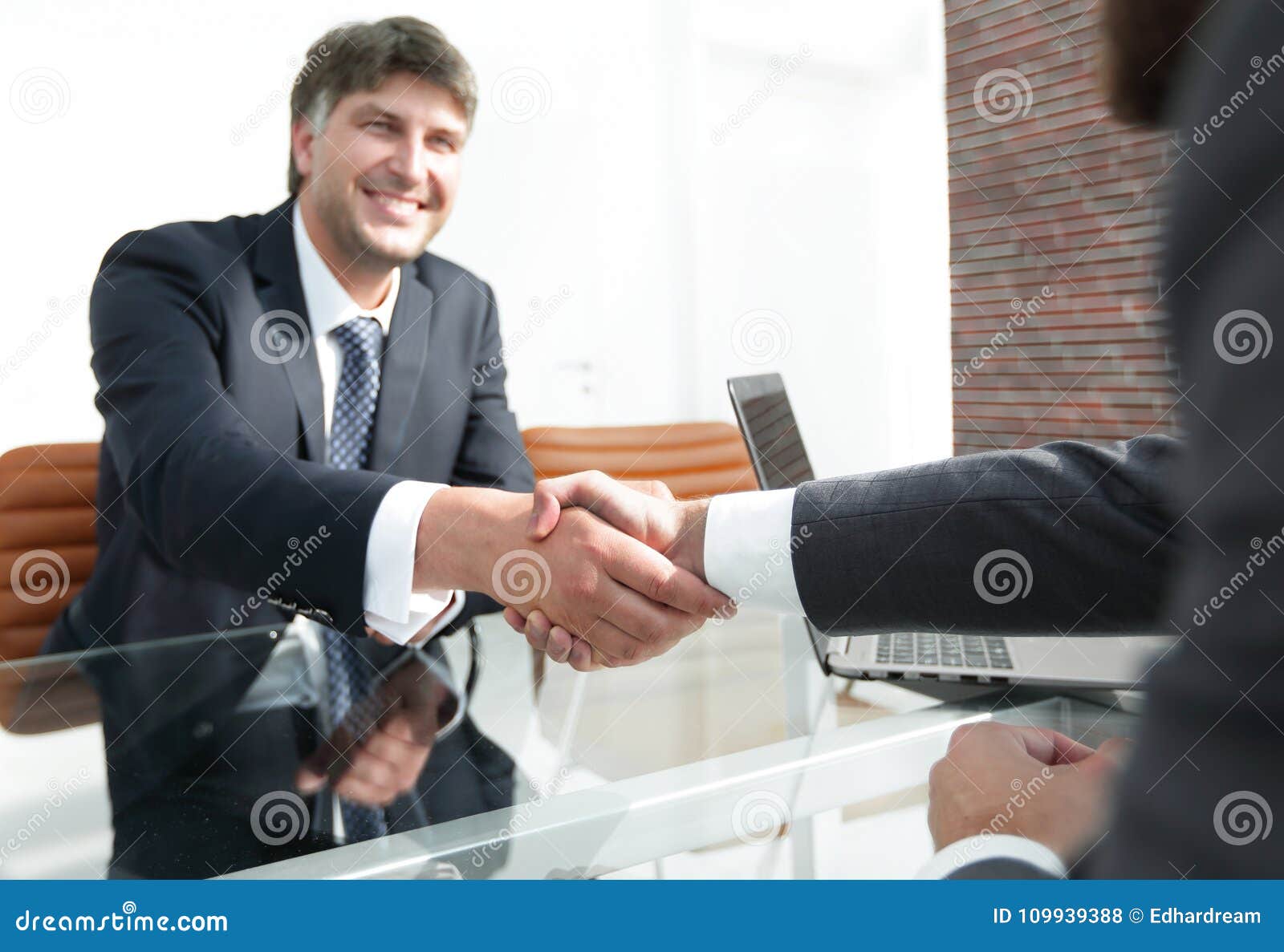 Businessman Stretches Out His Hand For A Handshake Stock