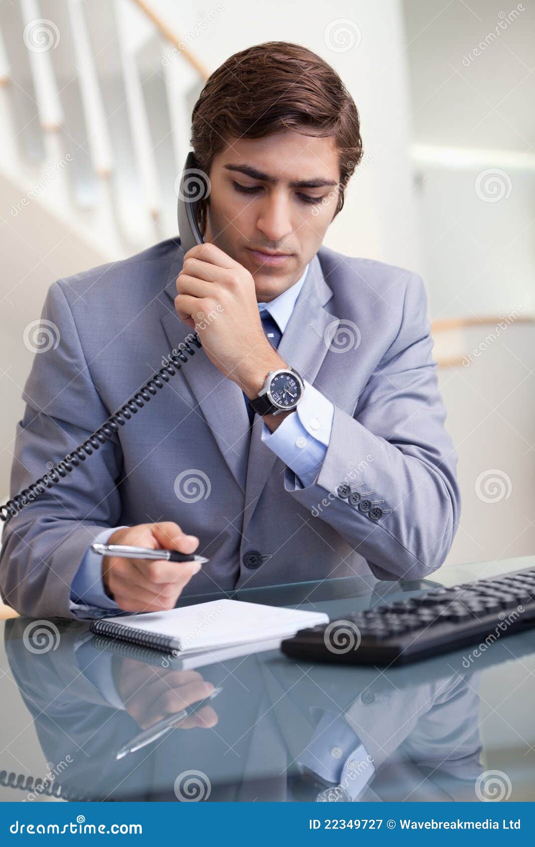 Businessman Taking Notes while on the Phone Stock Image - Image of ...