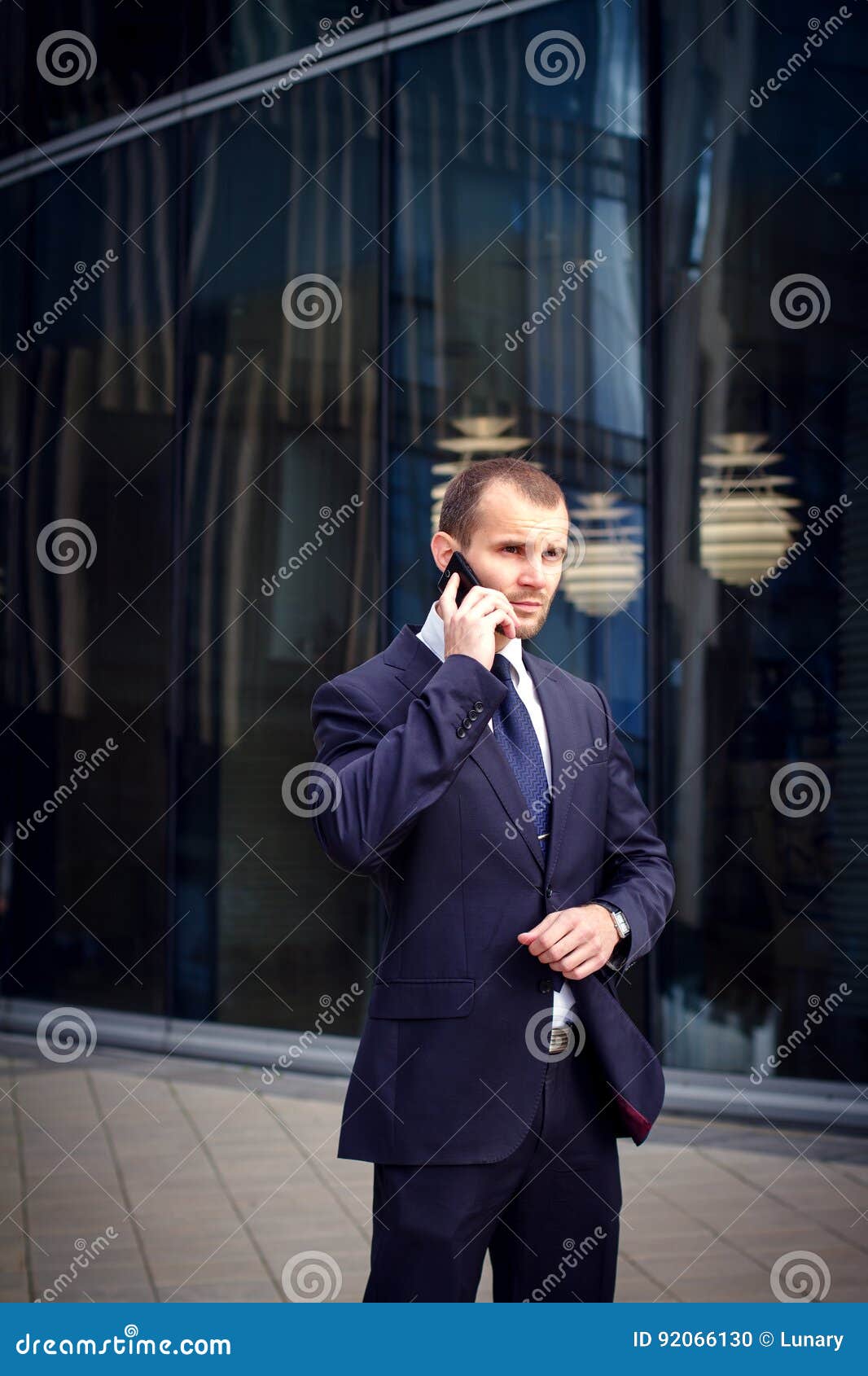 Businessman Talking On Cellphone Outdoors Businessman Talking On His Cellphone While Walking