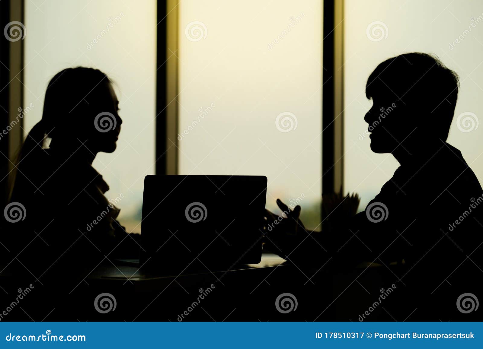 businessman is talking with his collegue in the evening time in the modern office