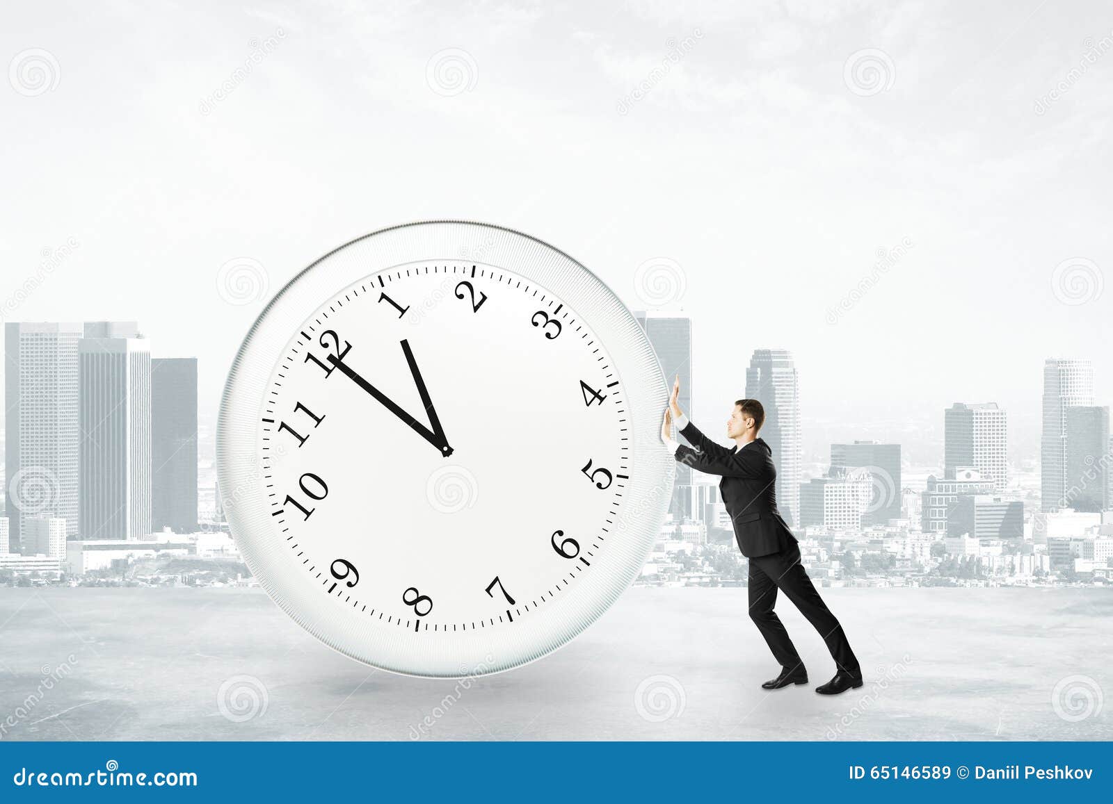 Businessman trying to stop time Stock Photo by ©kantver 69891211