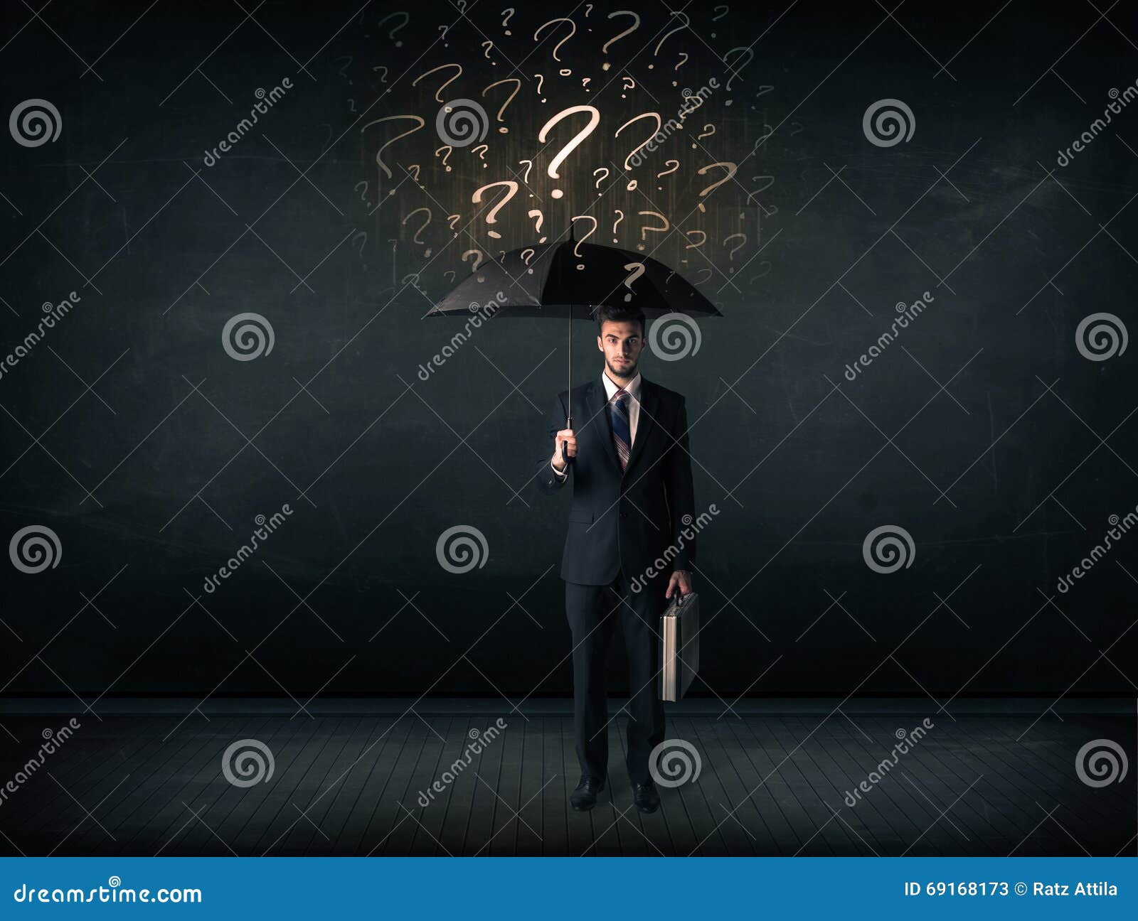 Businessman with Umbrella and a Lot of Drawn Question Marks Stock