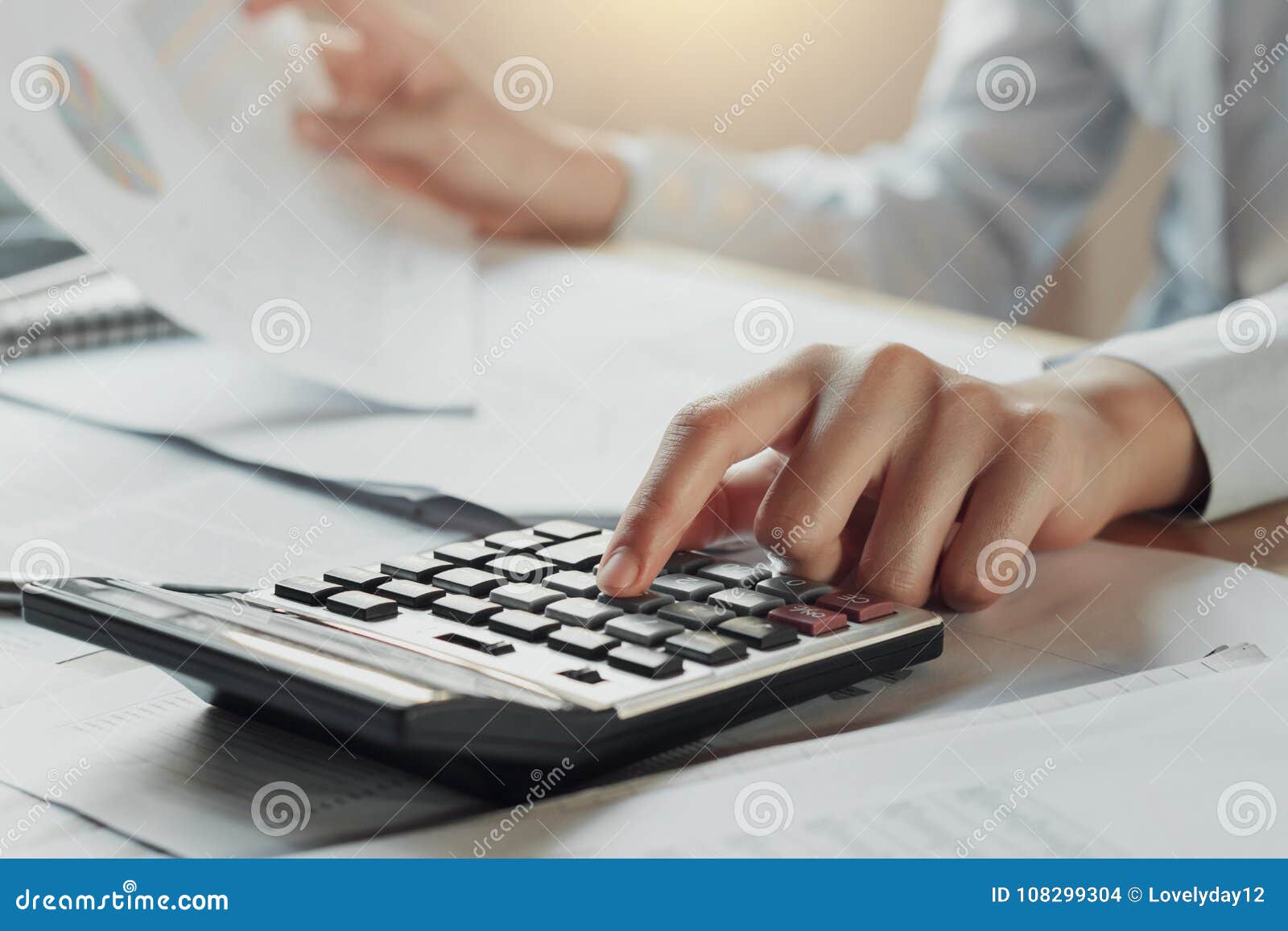 businessman using calculator for calculate budget on table in of