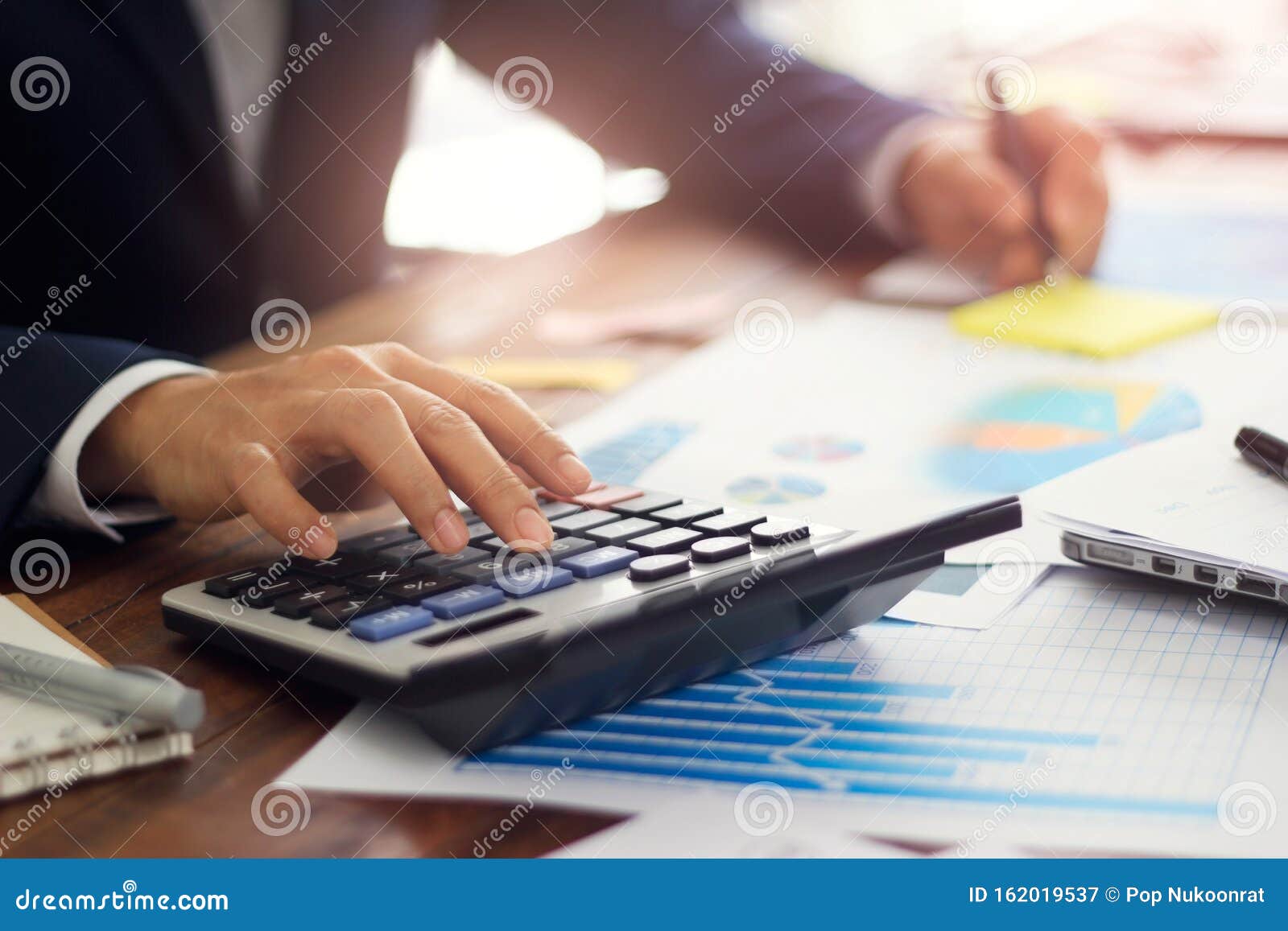 businessman using calculator to calculate budget, payments, business financing and accounting banking concept