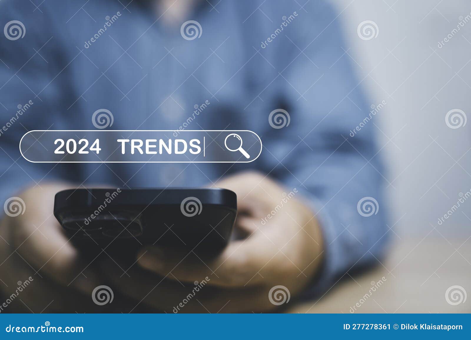 Businessman Using Smartphone To Input Keyword of 2024 Trends Inside