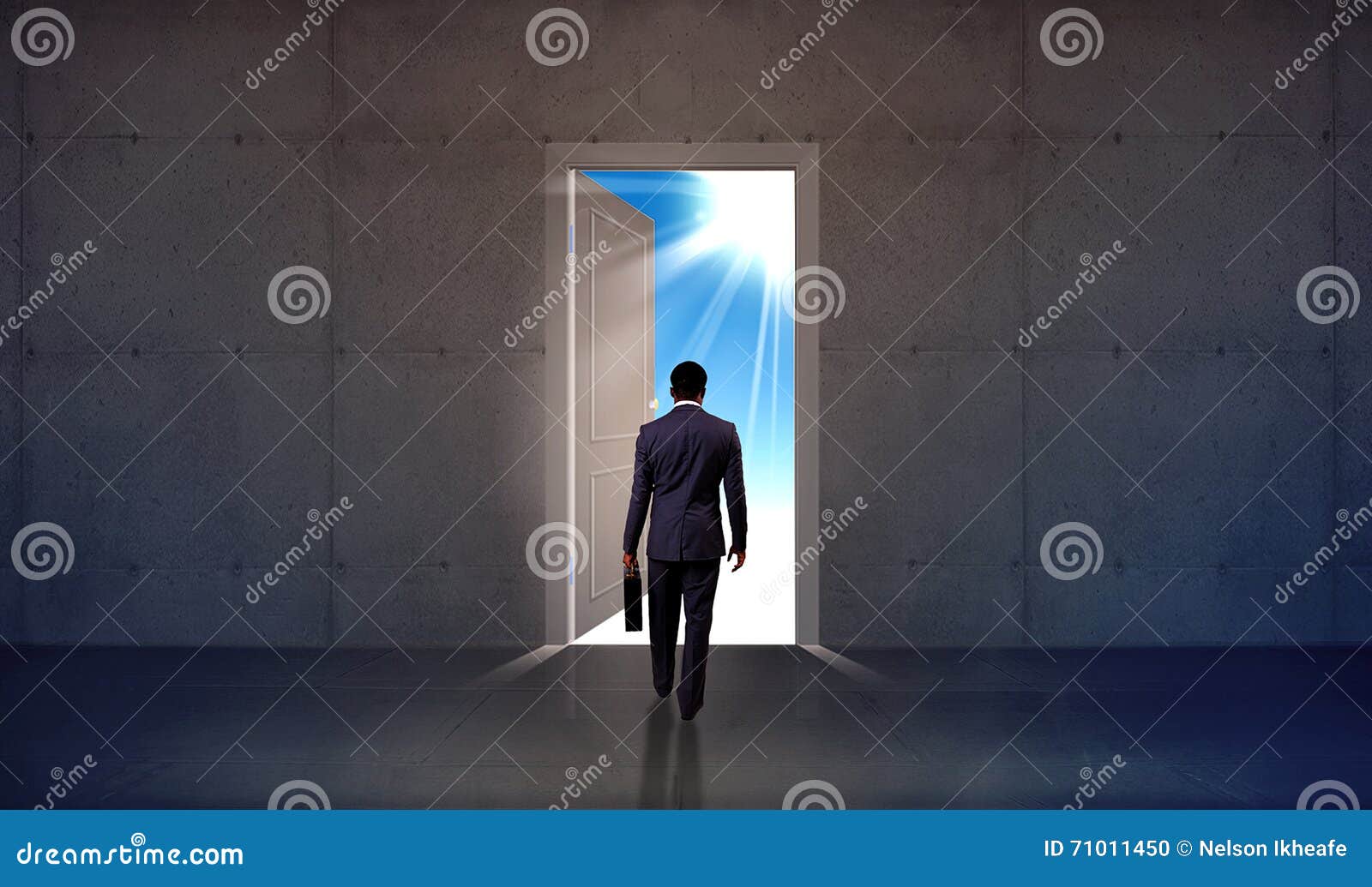 businessman walking through open door