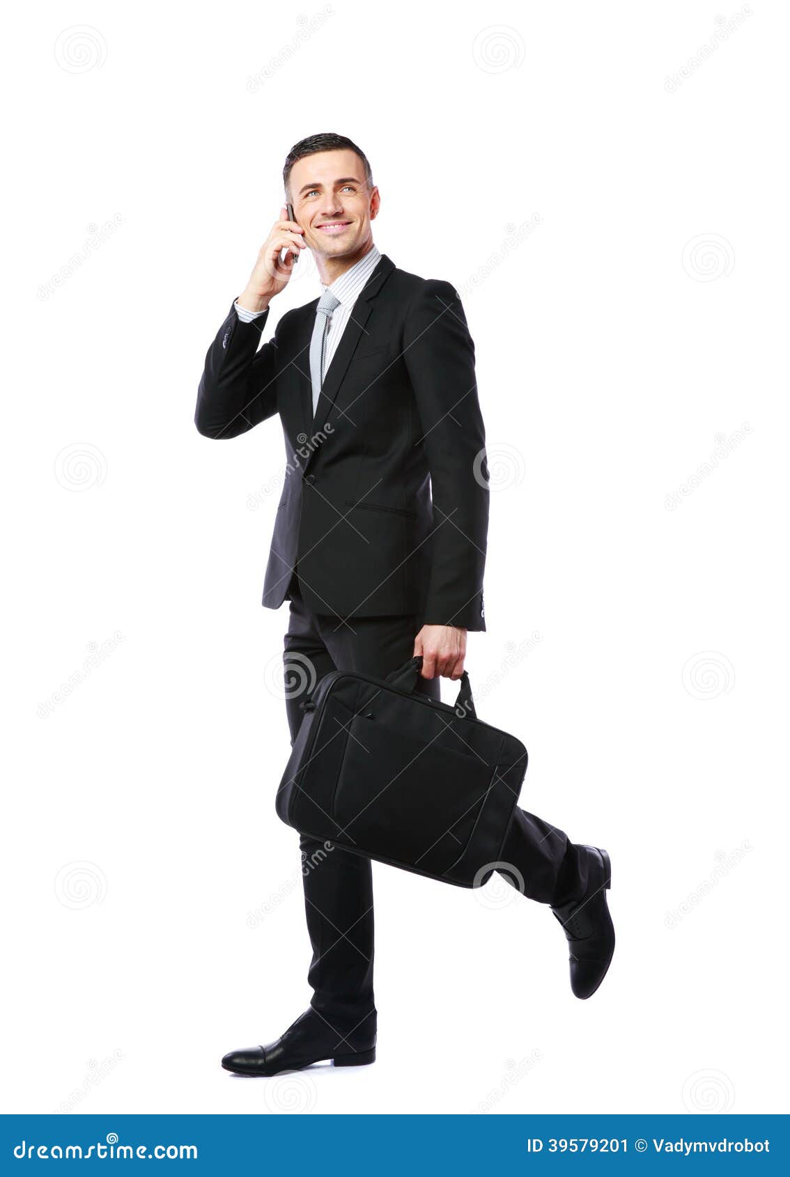 Businessman walking and talking on the phone over white background