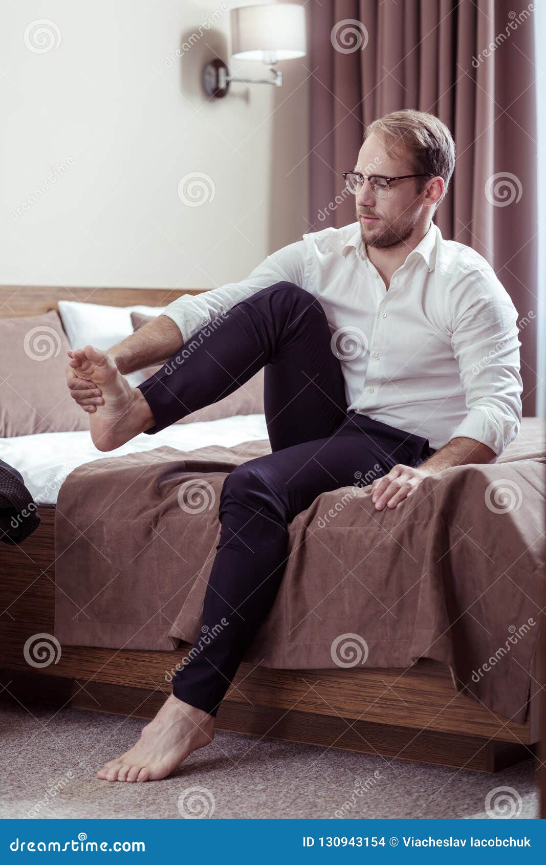 Businessman Wearing Glasses Taking His Shoes Off after Difficult Day ...