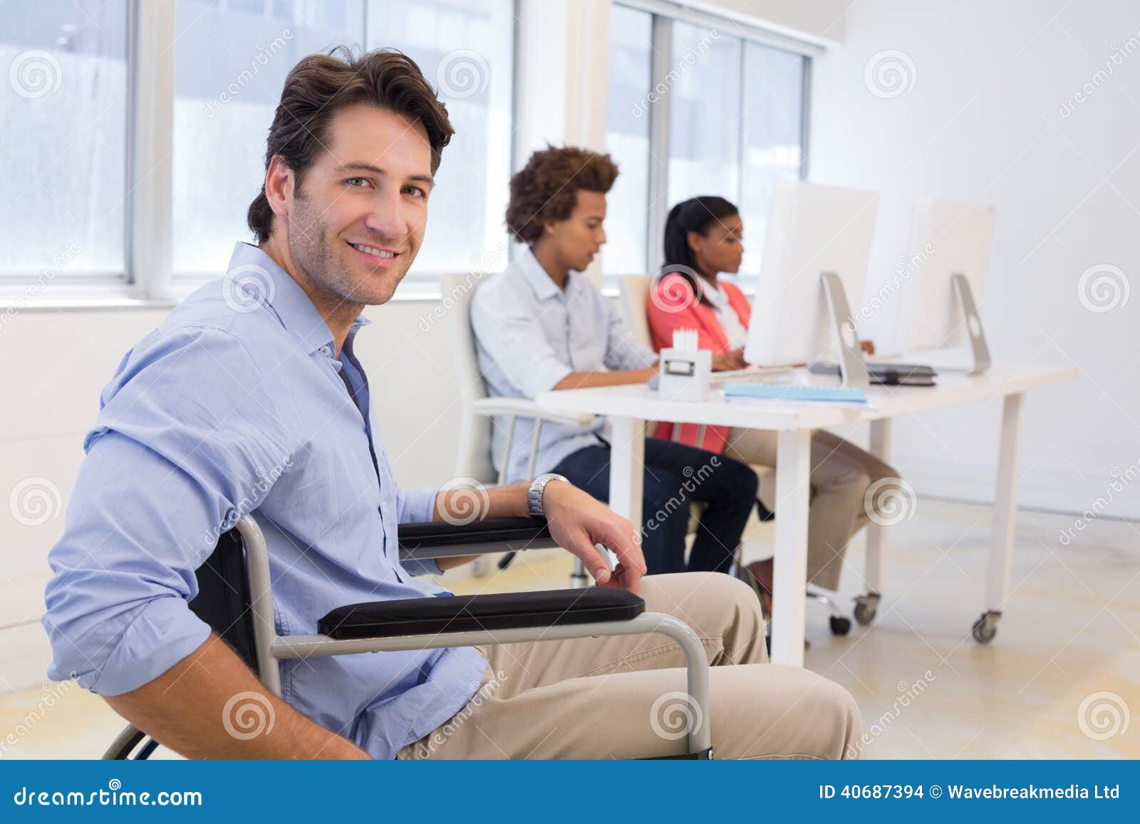 Businessman in Wheelchair with Disability at Work Stock Photo Image