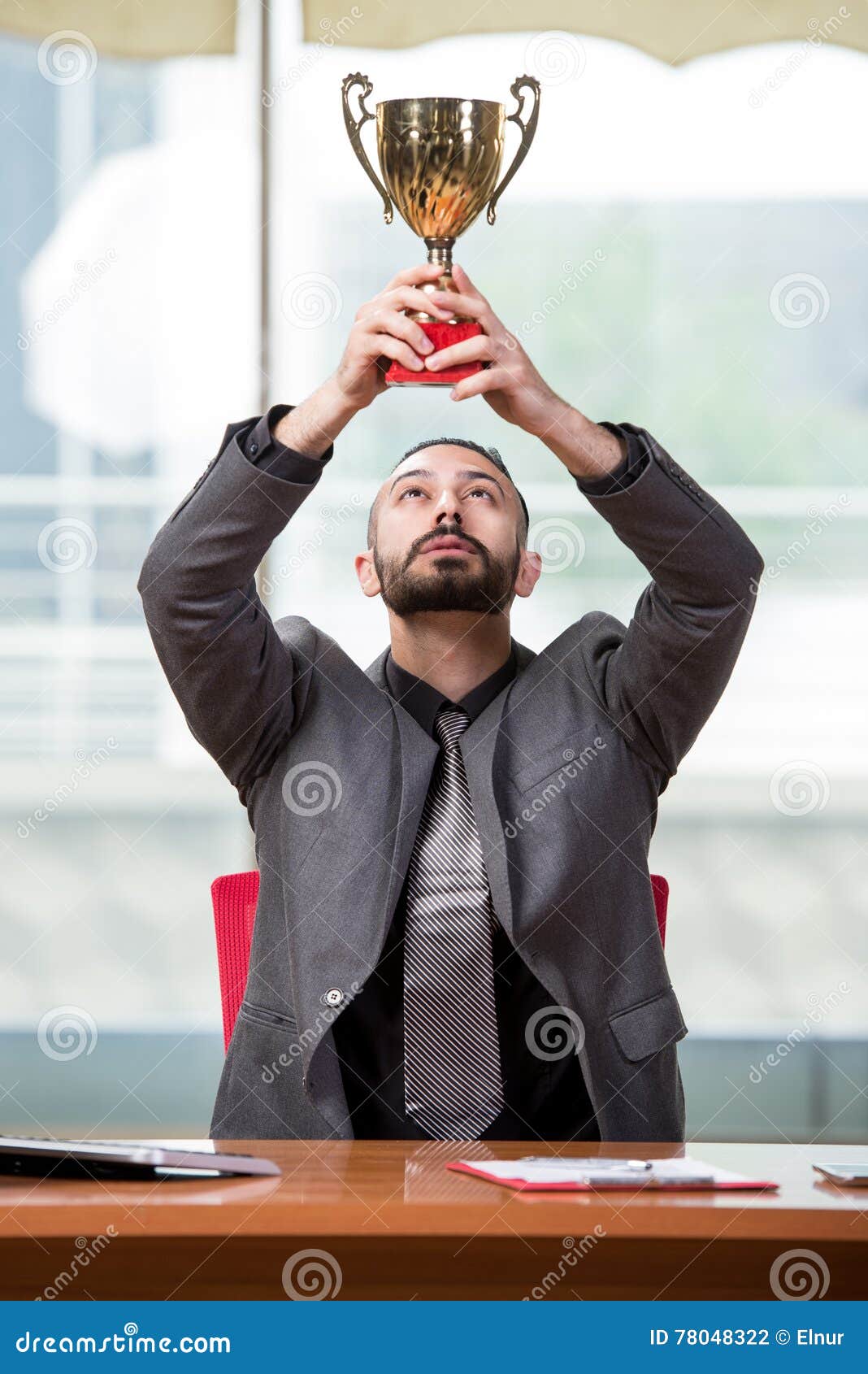 The Businessman with Winners Cup Trophy in Business Concept Stock Photo