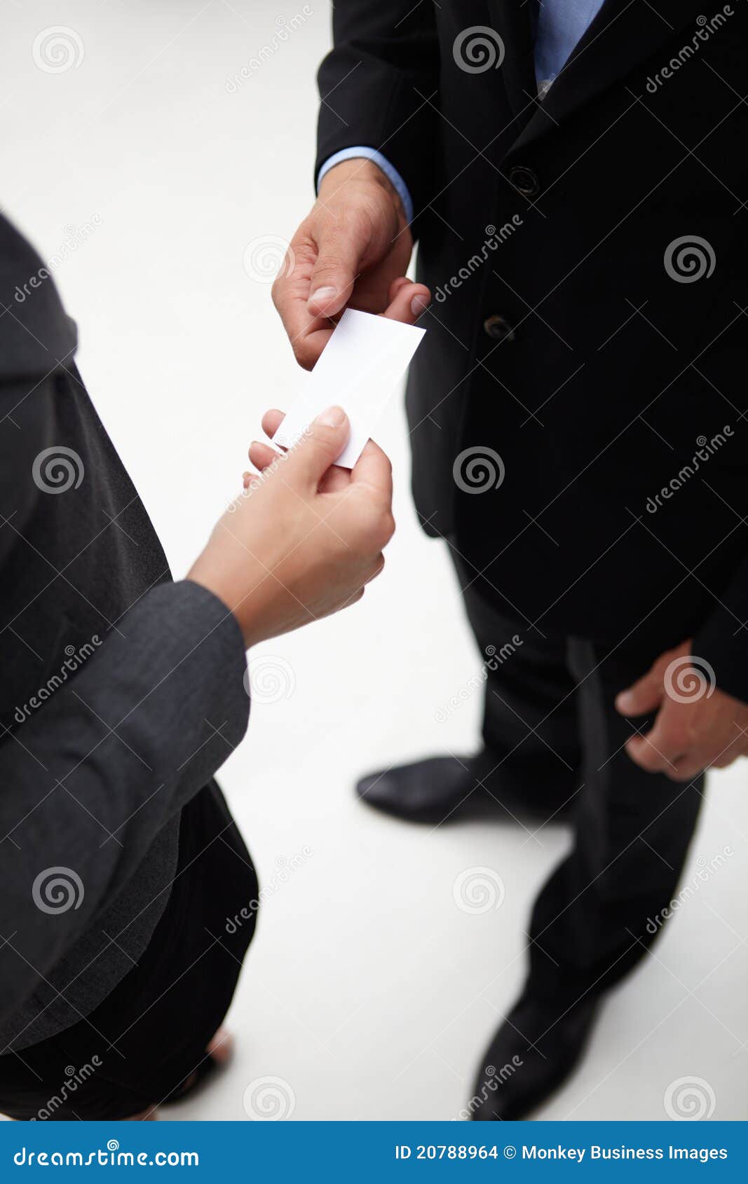 businessman and woman exchanging a business card