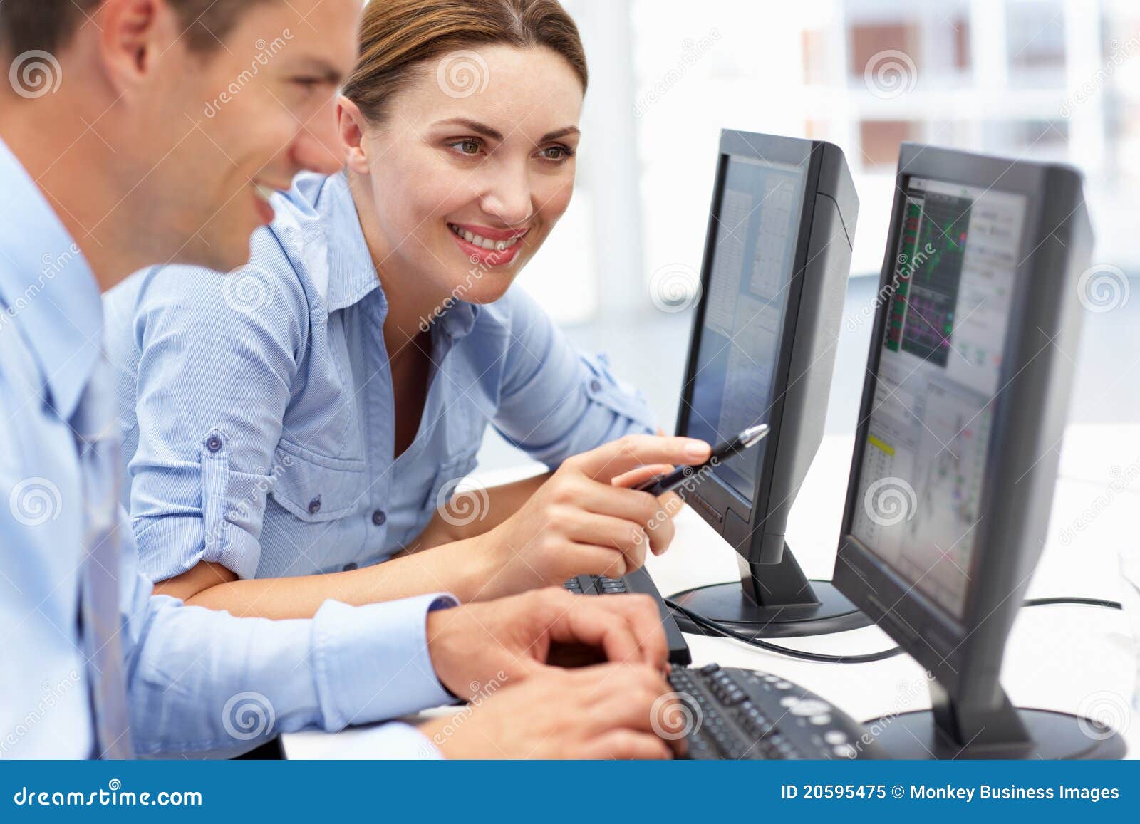 businessman and woman working on computers