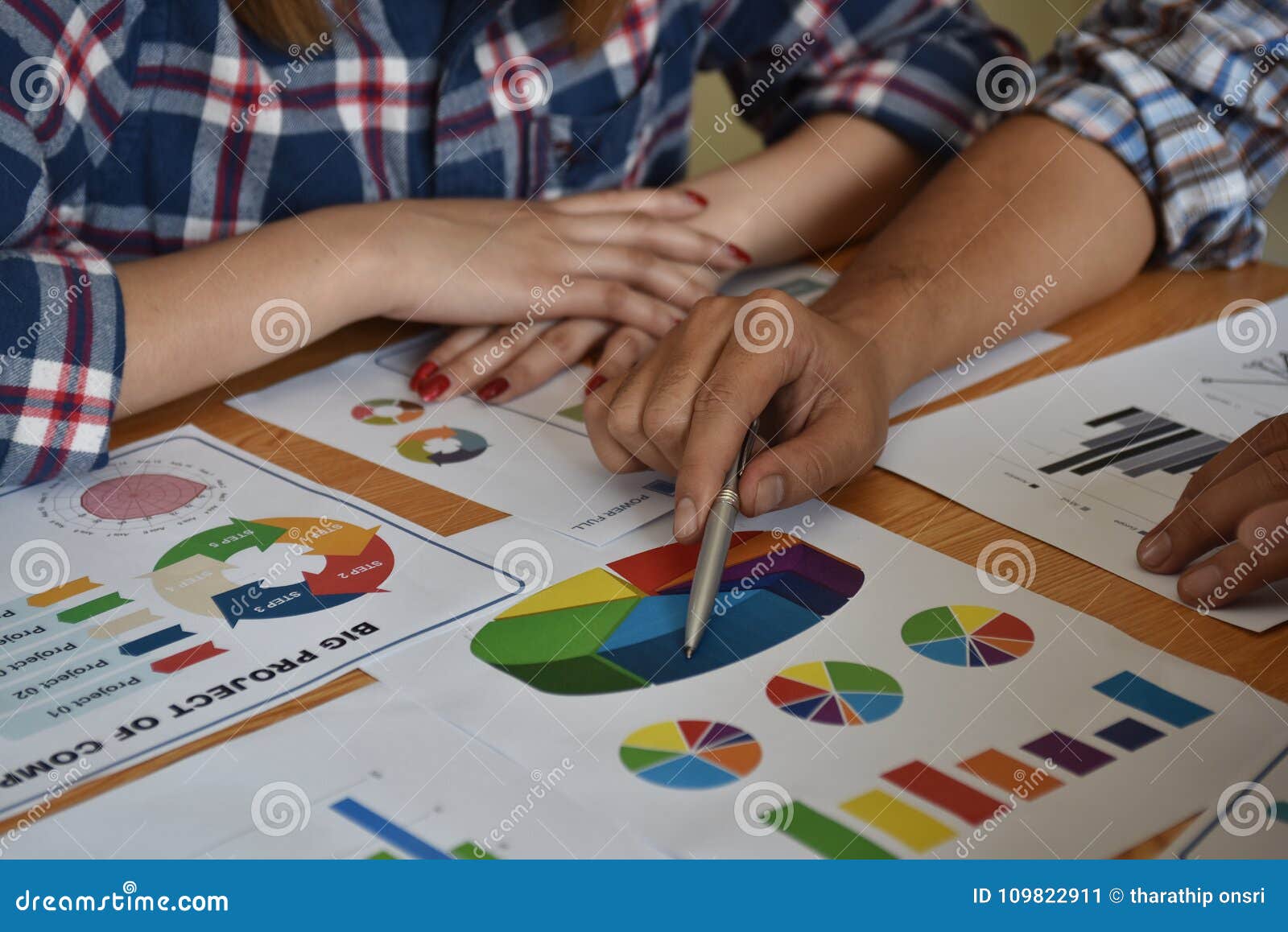 architect with business man and engineer are planning on blueprint. architect is pointing on the blueprint.