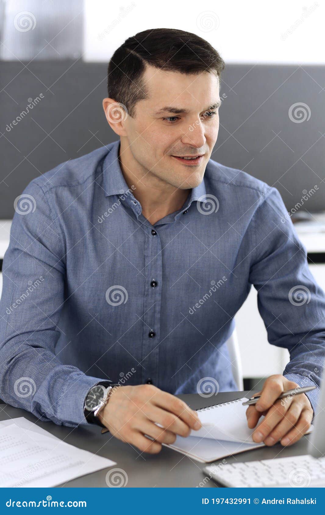 Businessman working with computer in modern office. Headshot of male entrepreneur or company director at workplace. Business concept.