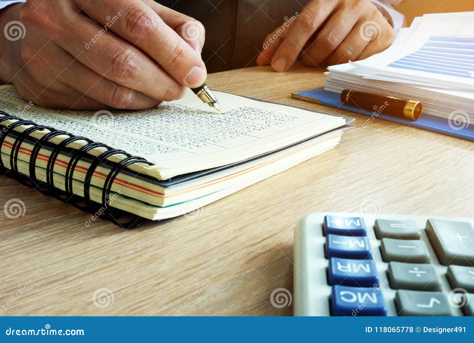 businessman writing financial results in book. bookkeeping concept.
