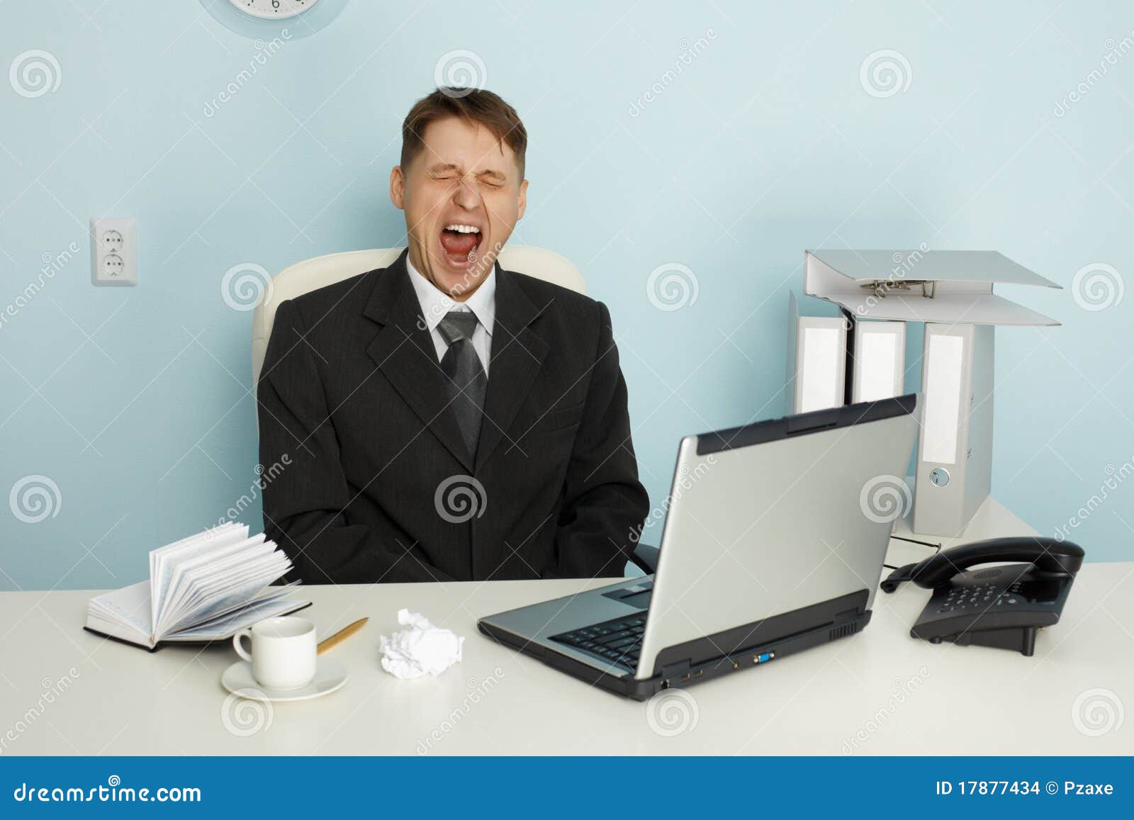 businessman yawning from boredom and idleness