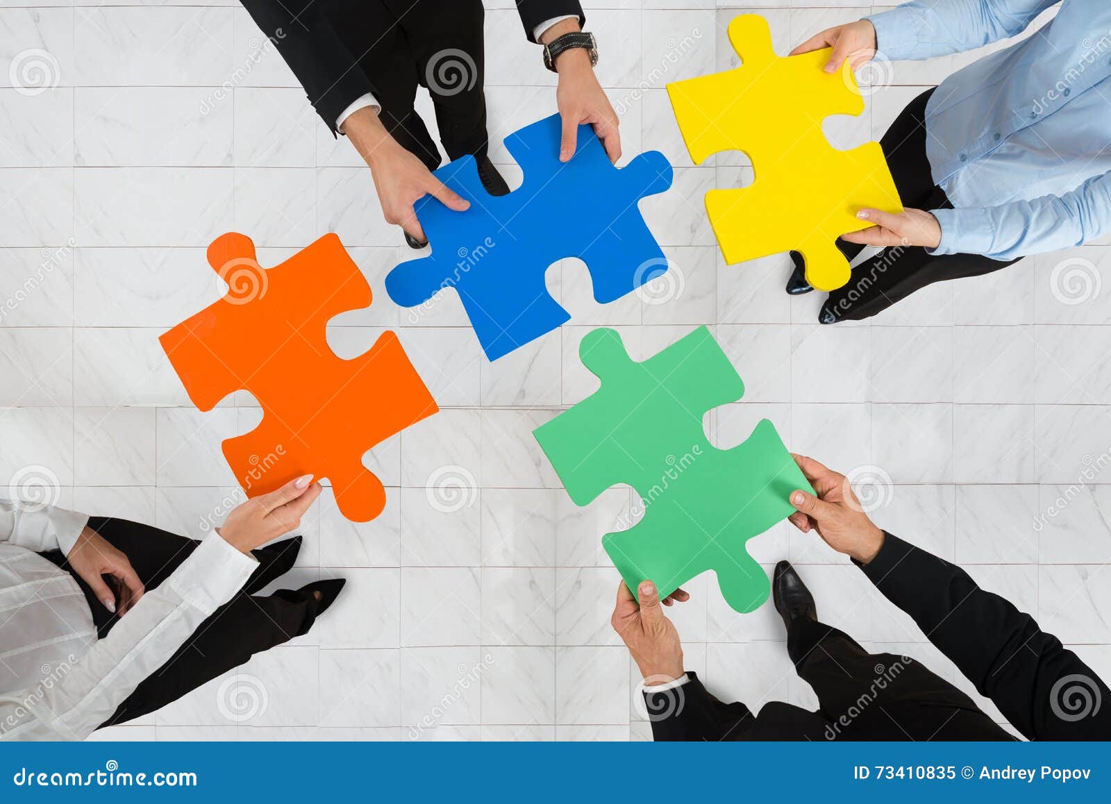 businesspeople holding puzzle pieces