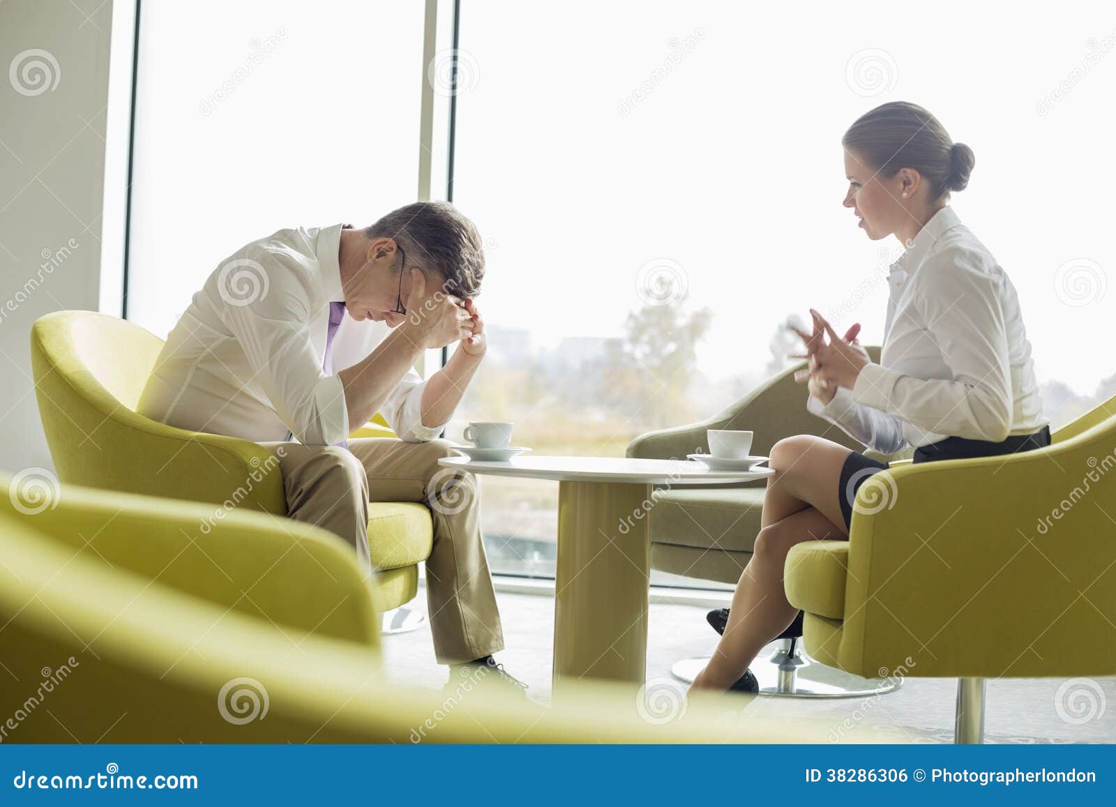 businesspeople in serious discussion at office lobby