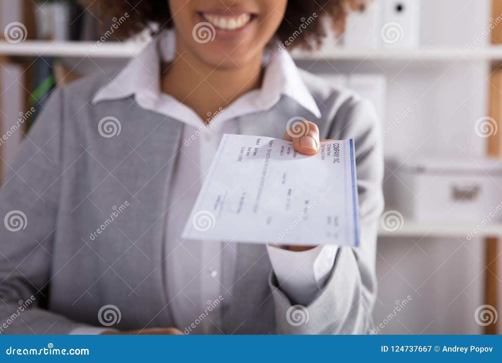 businessperson giving cheque in office