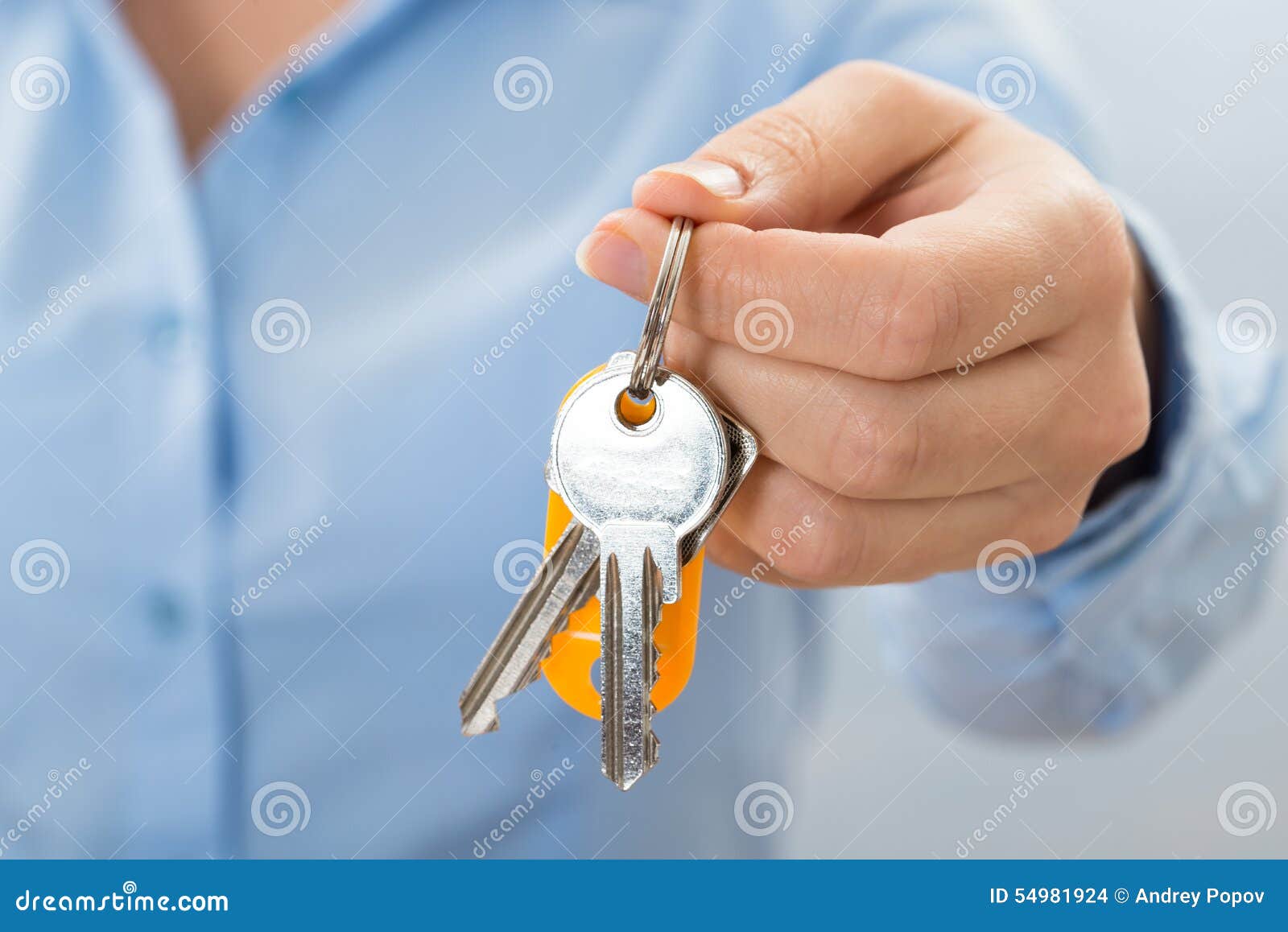 businessperson hand holding key
