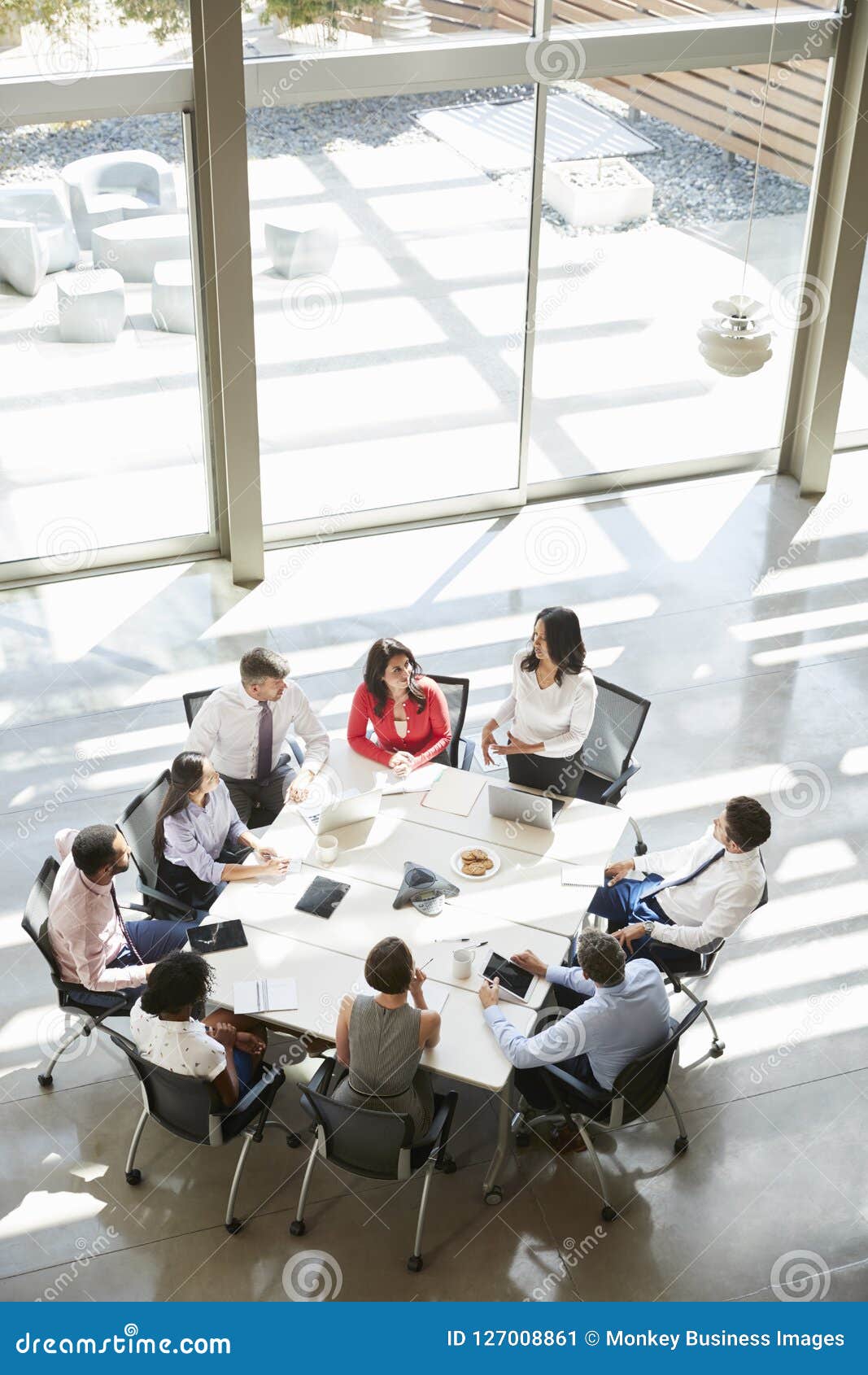 businesswoman addressing meeting, elevated view, vertical