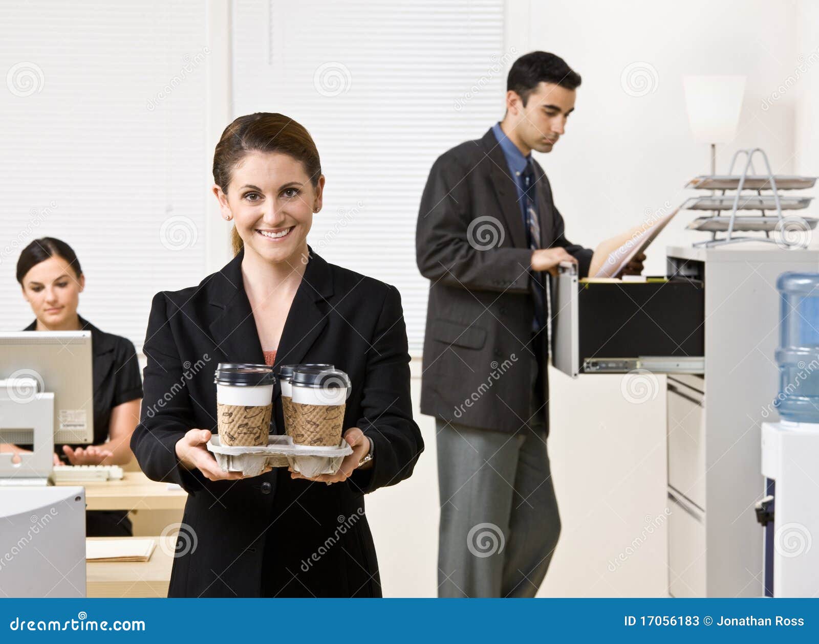 businesswoman carrying tray of coffee