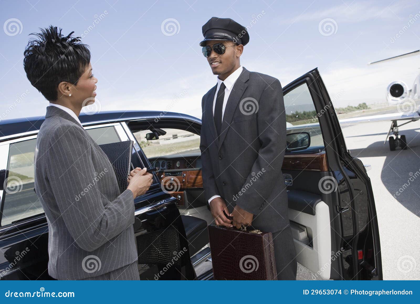 businesswoman communicating with driver on airfield