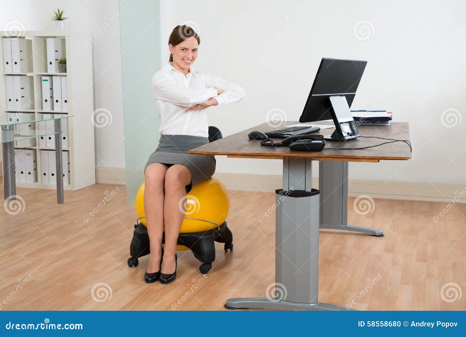 businesswoman exercising on pilates ball