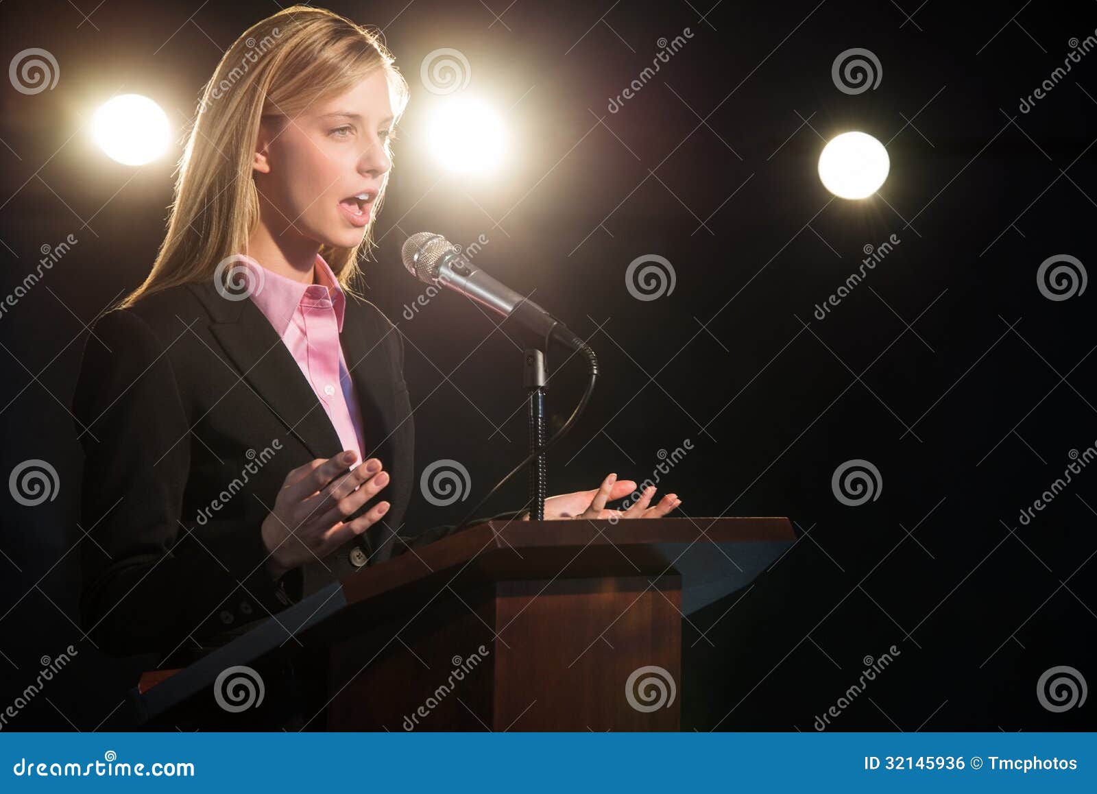 A moai behind a podium giving a speech