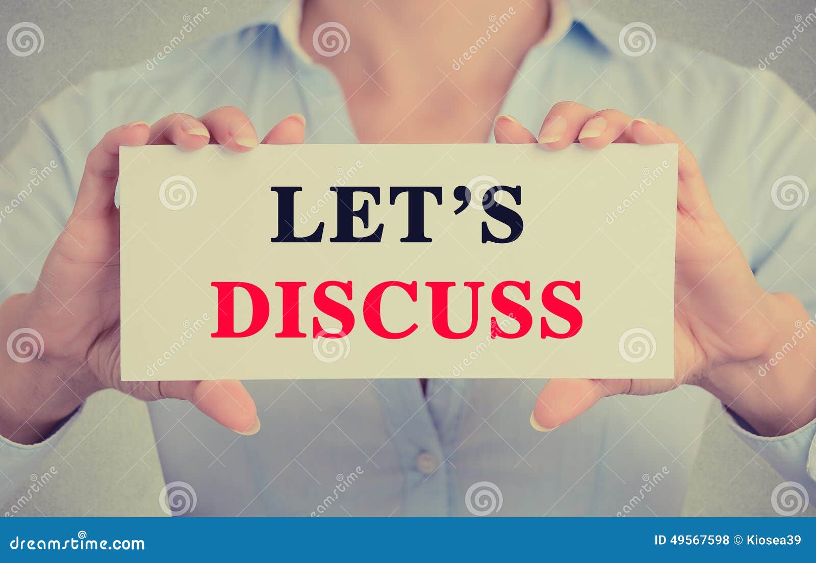 businesswoman hands holding card sign with let's discuss message