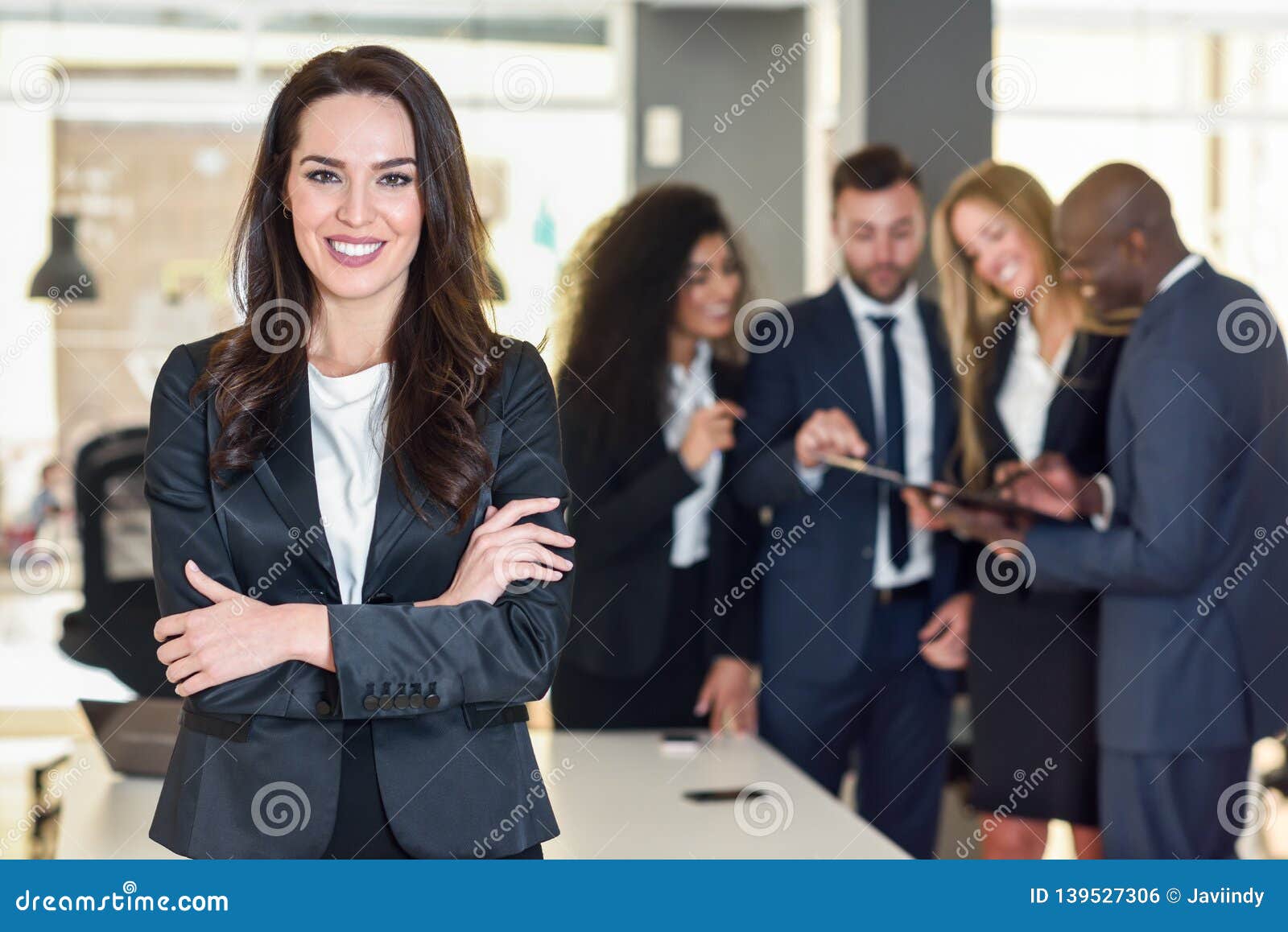 businesswoman leader in modern office with businesspeople working at background