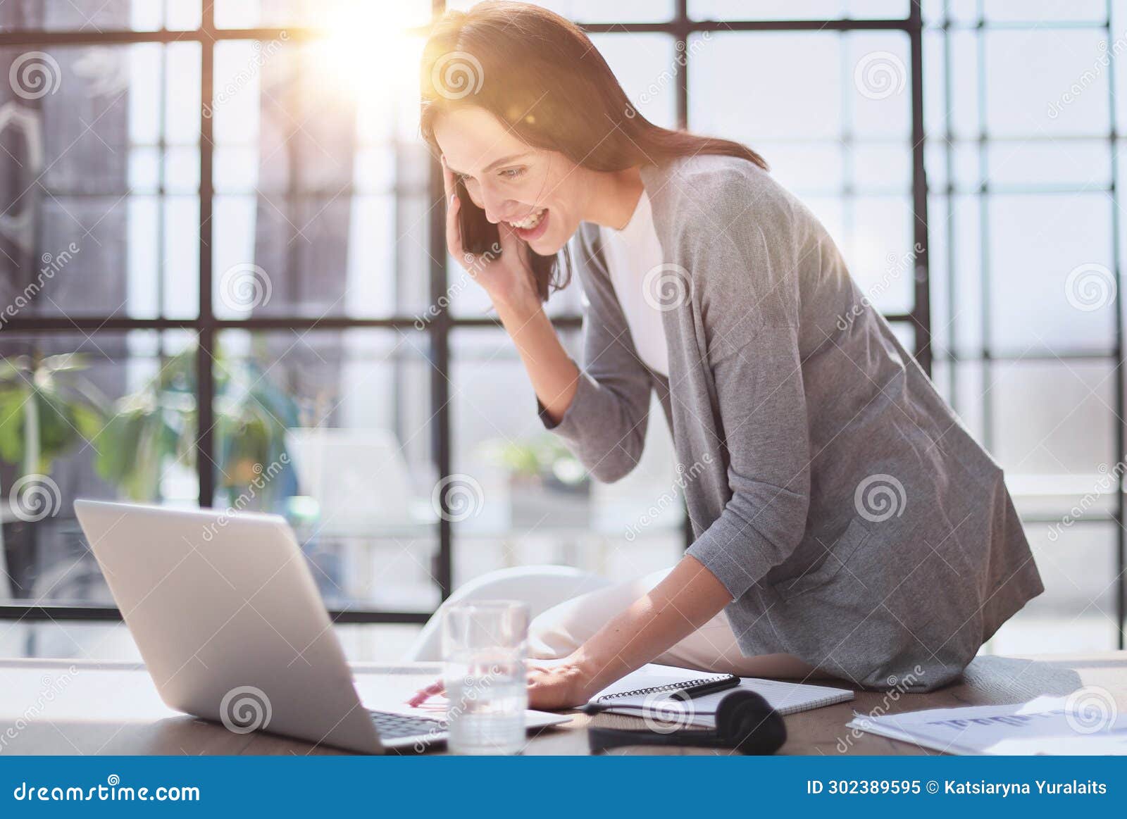 businesswoman with phone in modern office talking