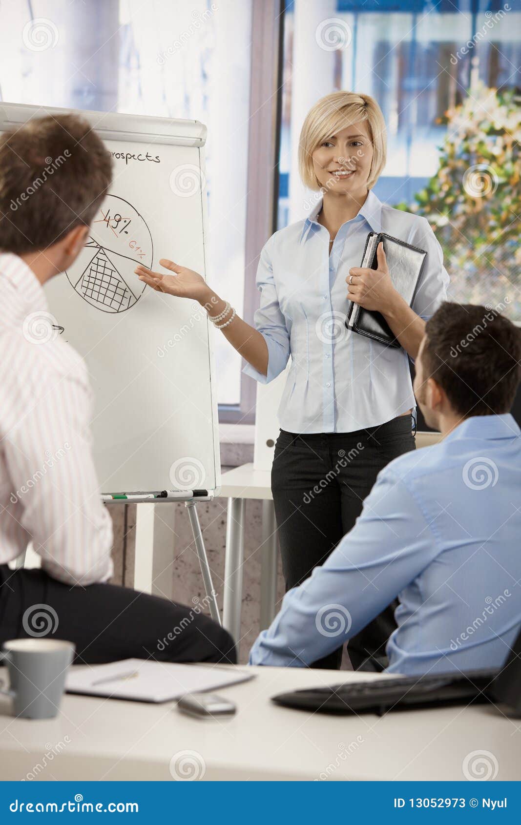 businesswoman presenting idea in office