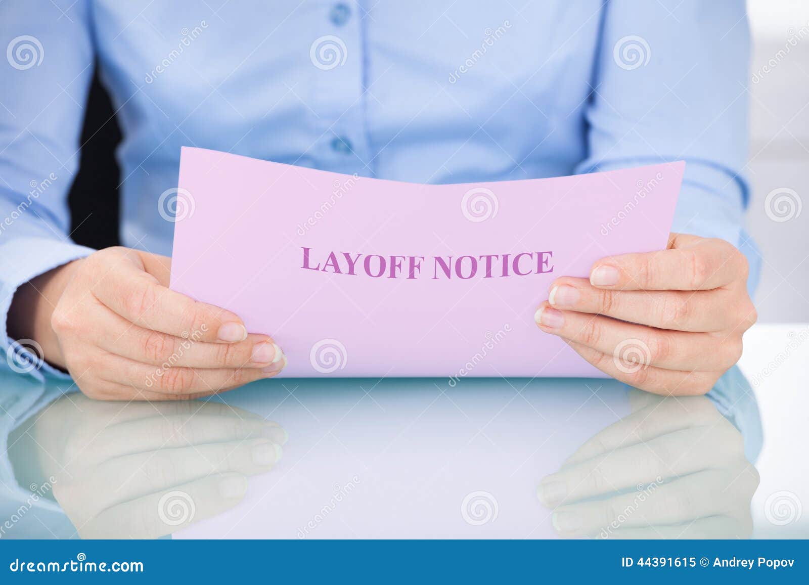 businesswoman reading layoff notice