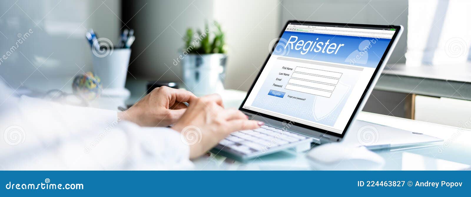 businesswoman`s hand filing online registration form