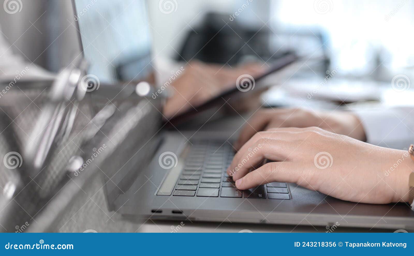 businesswoman`s hand presses on a laptop keyboard
