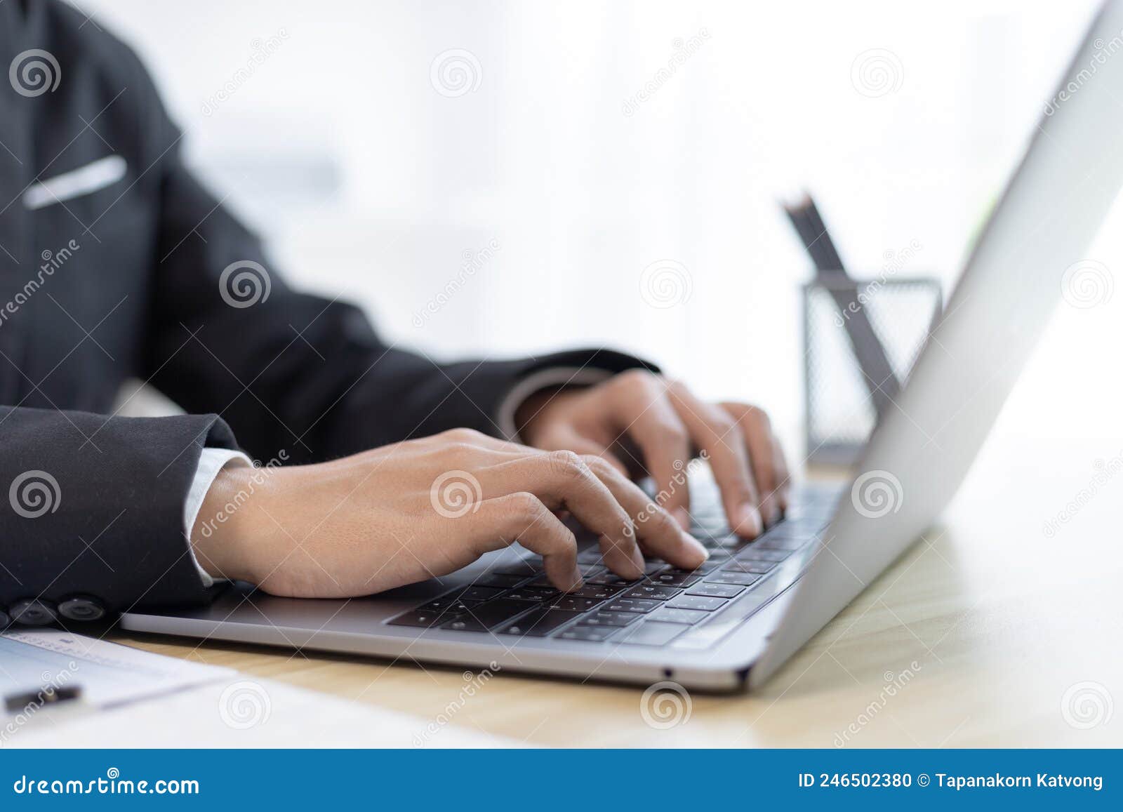businesswoman`s hand presses on a laptop keyboard