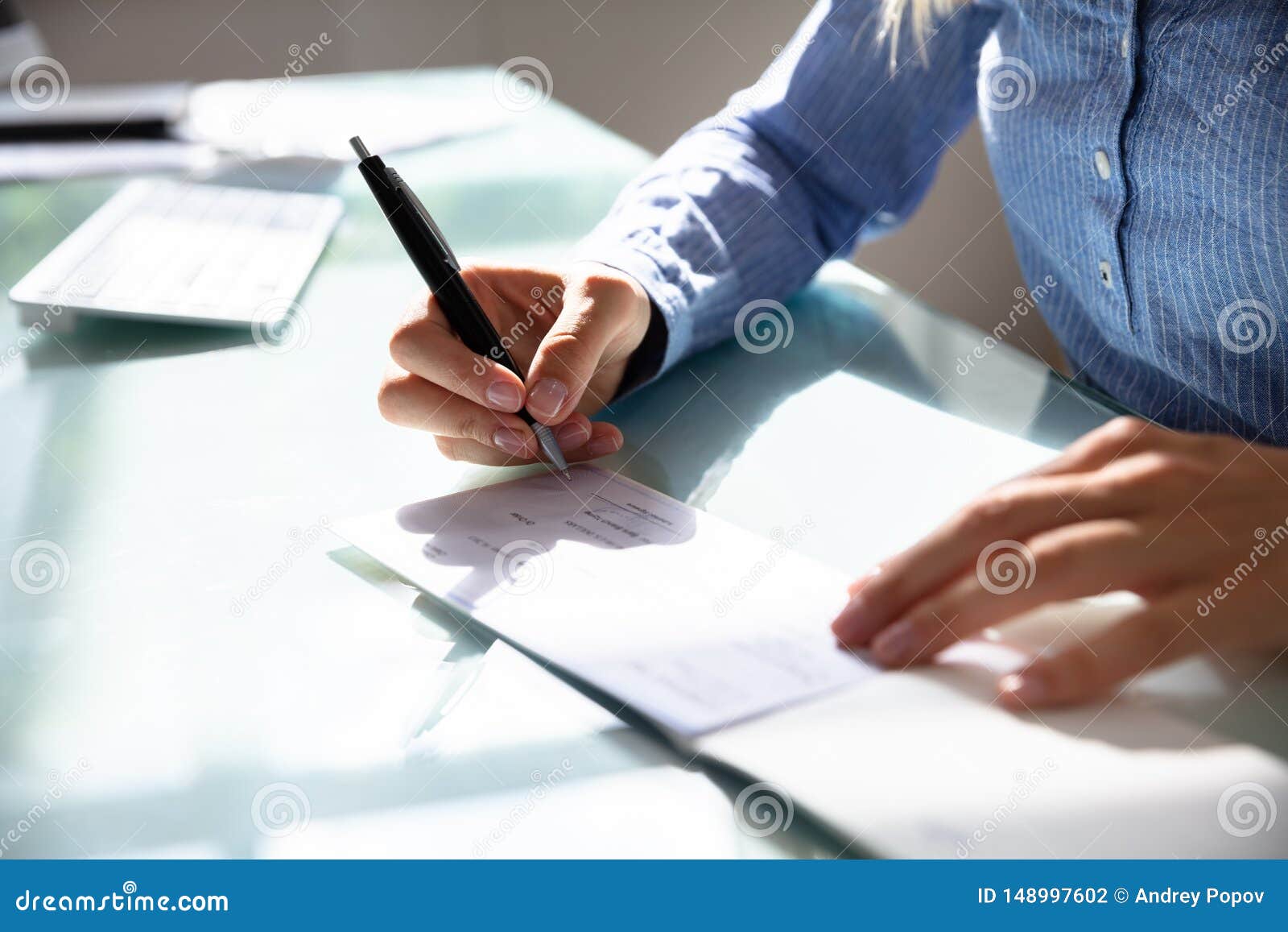 businesswoman signing cheque