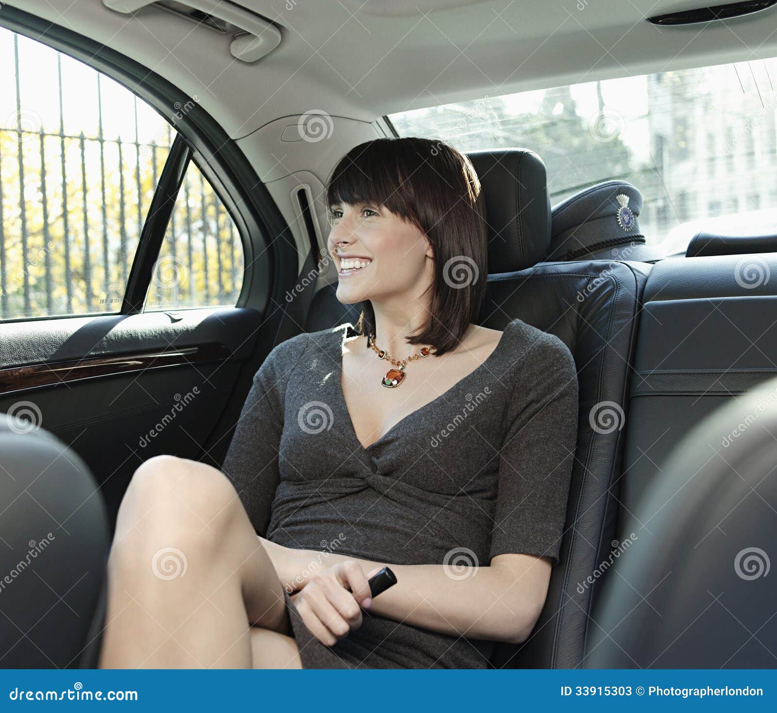 Businesswoman Sitting At Back Seat Of Car Stock Image